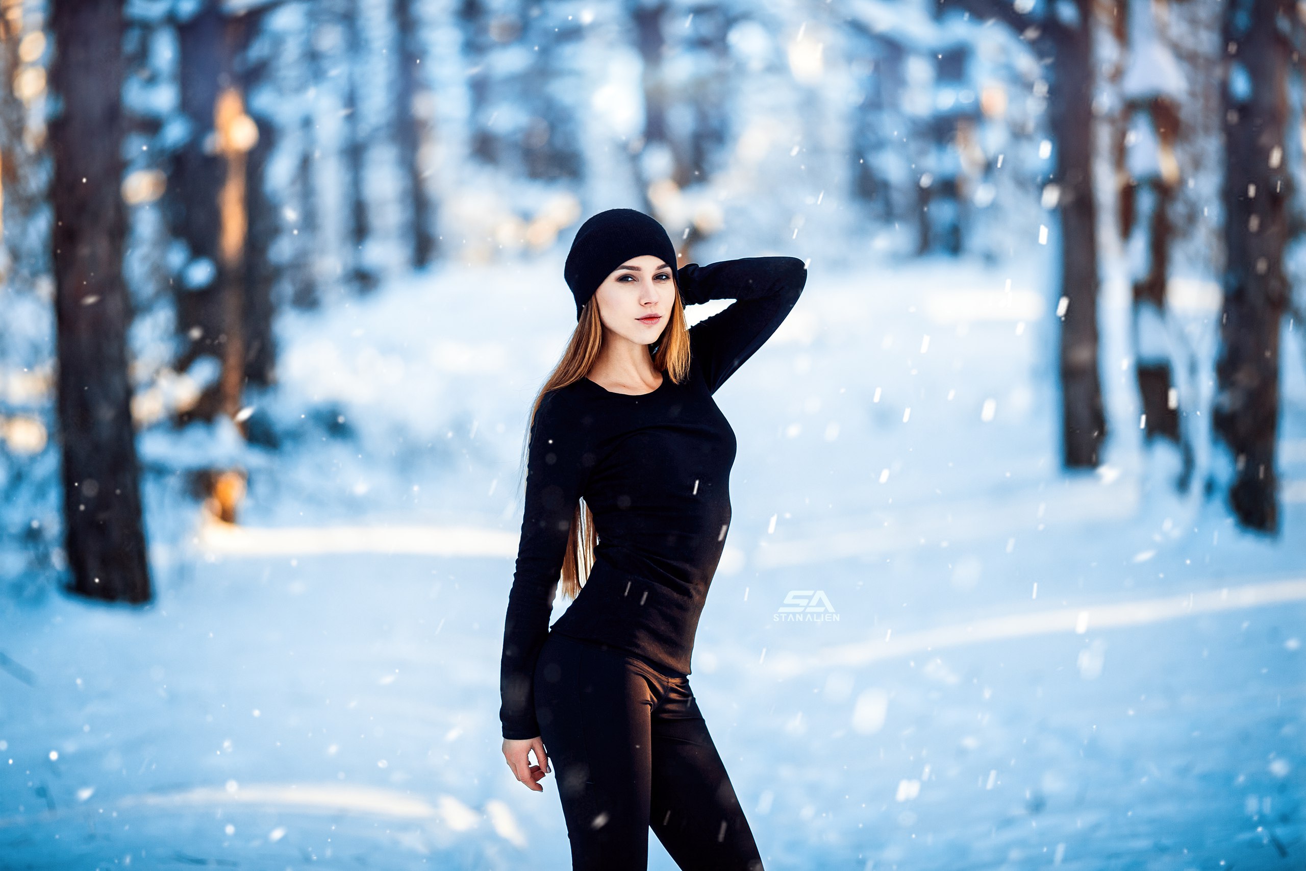 Woman in black clothing in a snowy forest HD Wallpaper