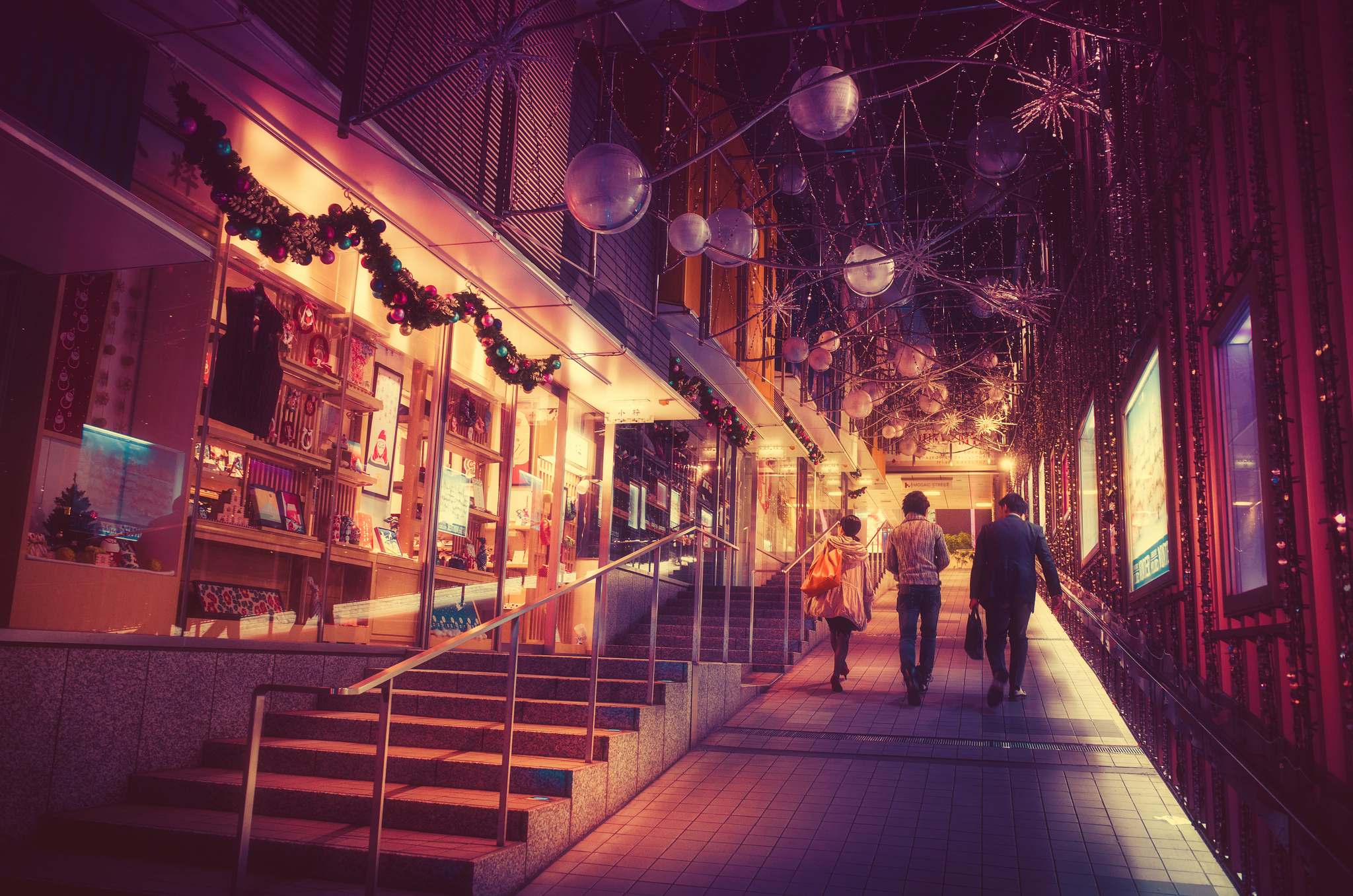 People walking on a street decorated for Christmas at night in Japan HD Wallpaper