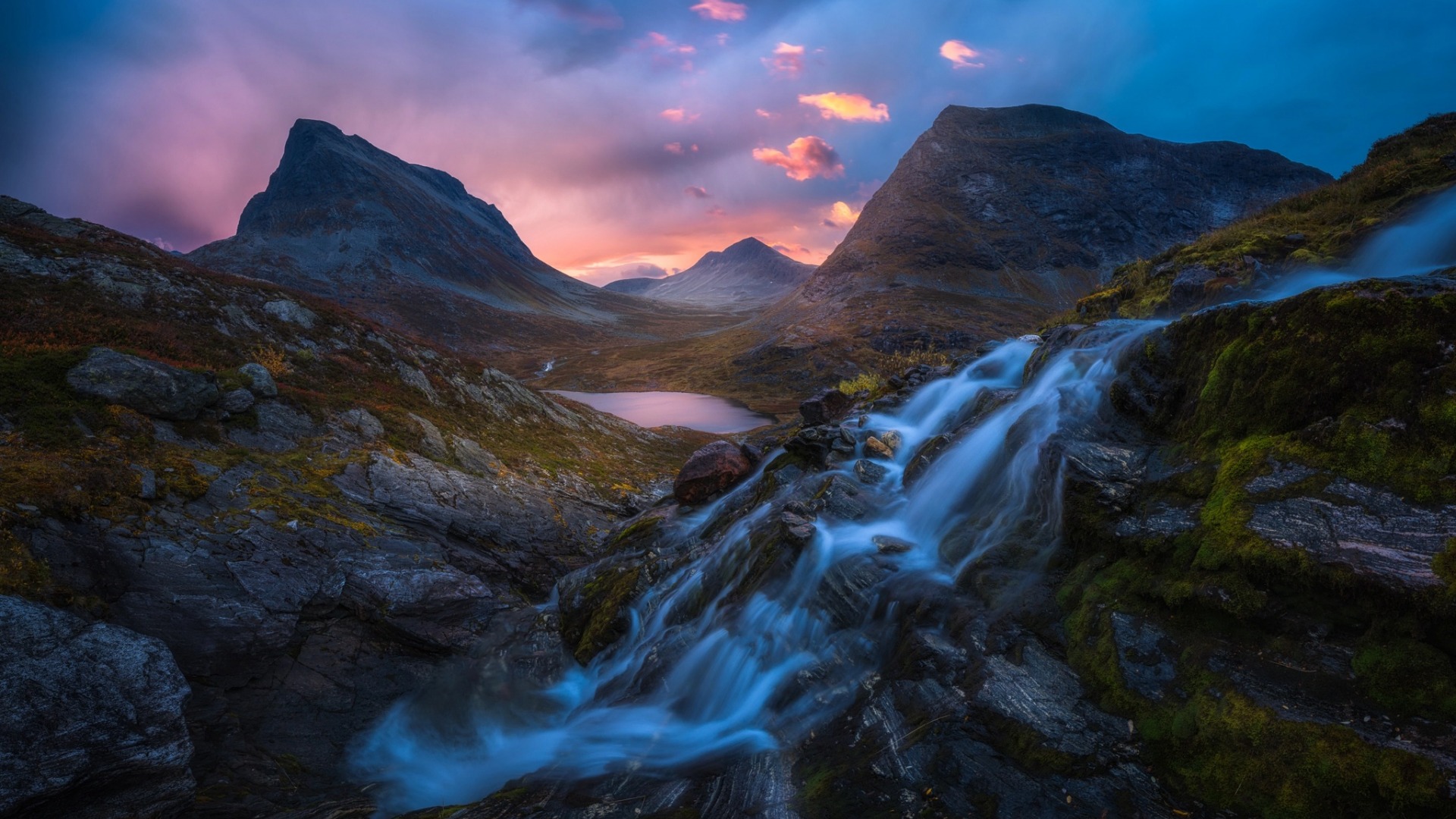Waterfall flowing through mountains at sunrise HD Wallpaper