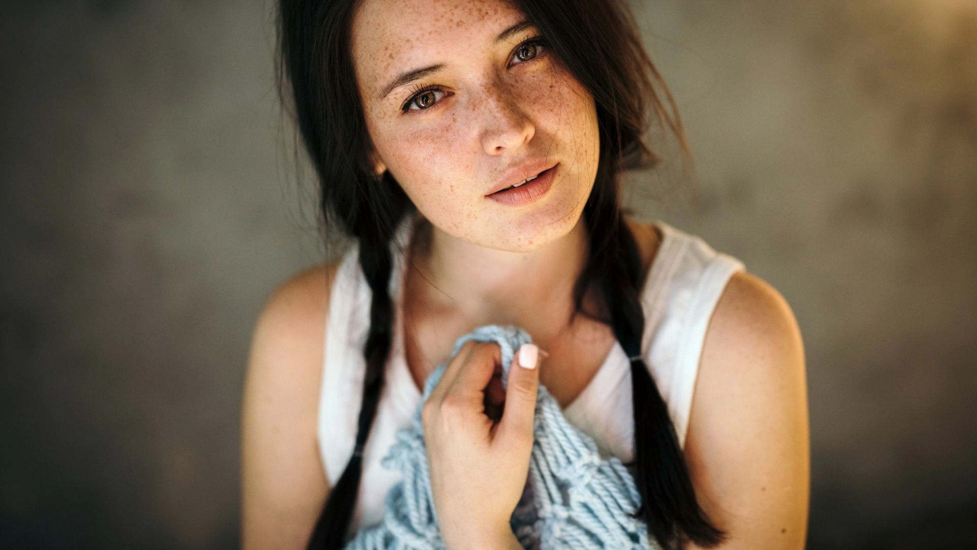 Woman with freckles and pigtails holding a blue scarf HD Wallpaper