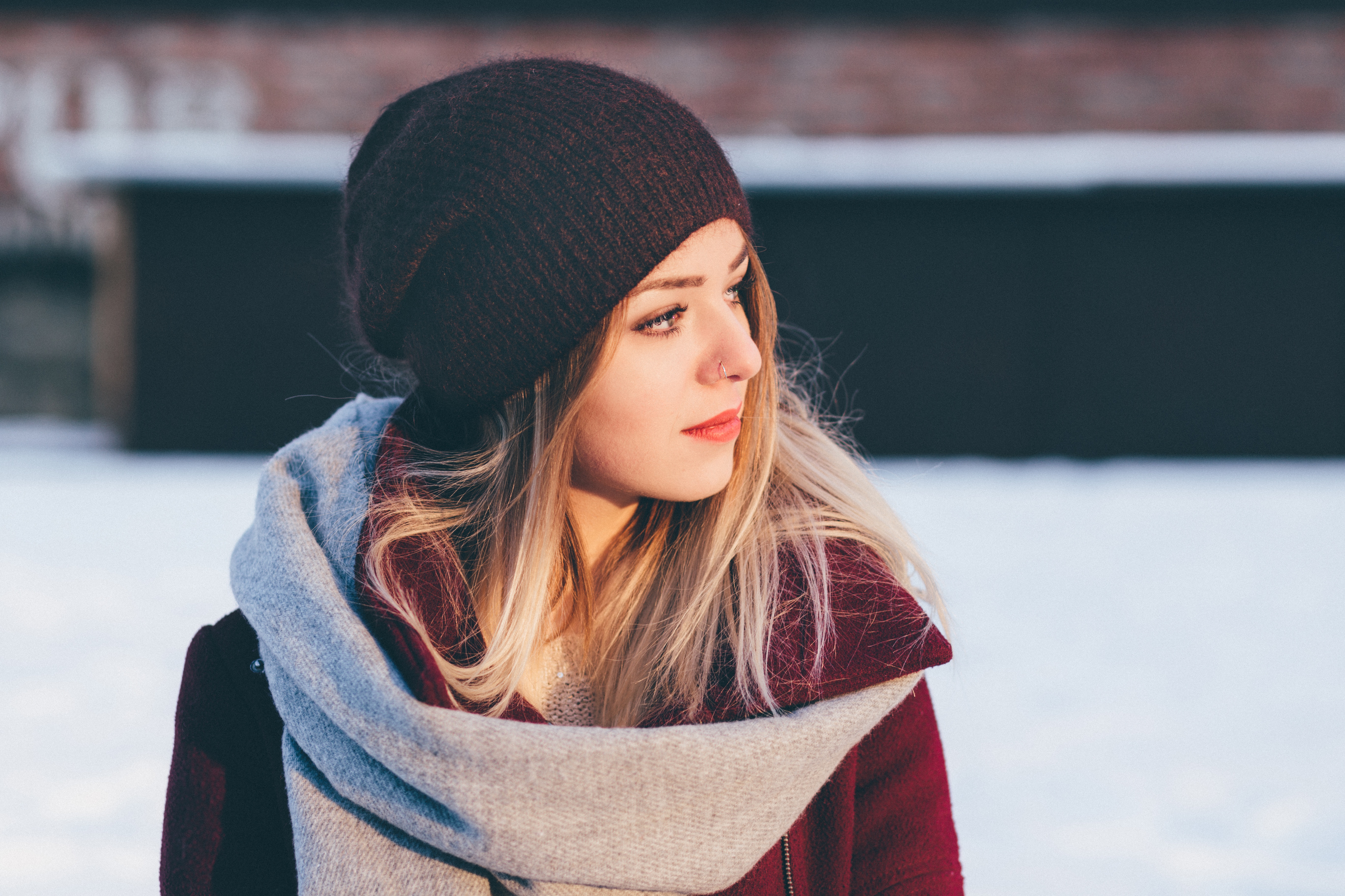 Woman wearing a hat and scarf in the snow HD Wallpaper