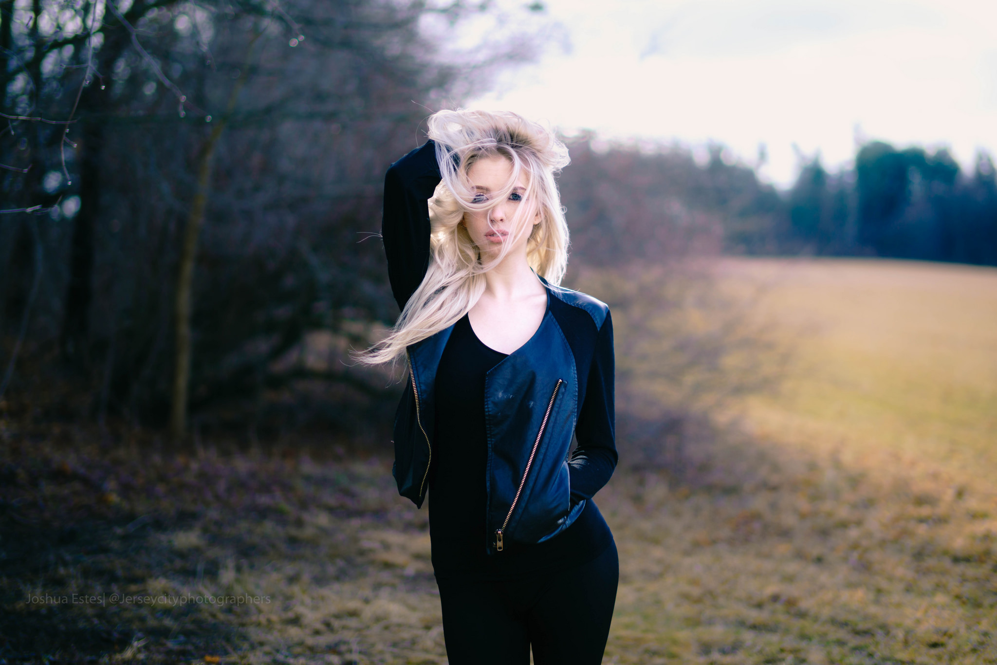Woman with blonde hair in a leather jacket outdoors HD Wallpaper