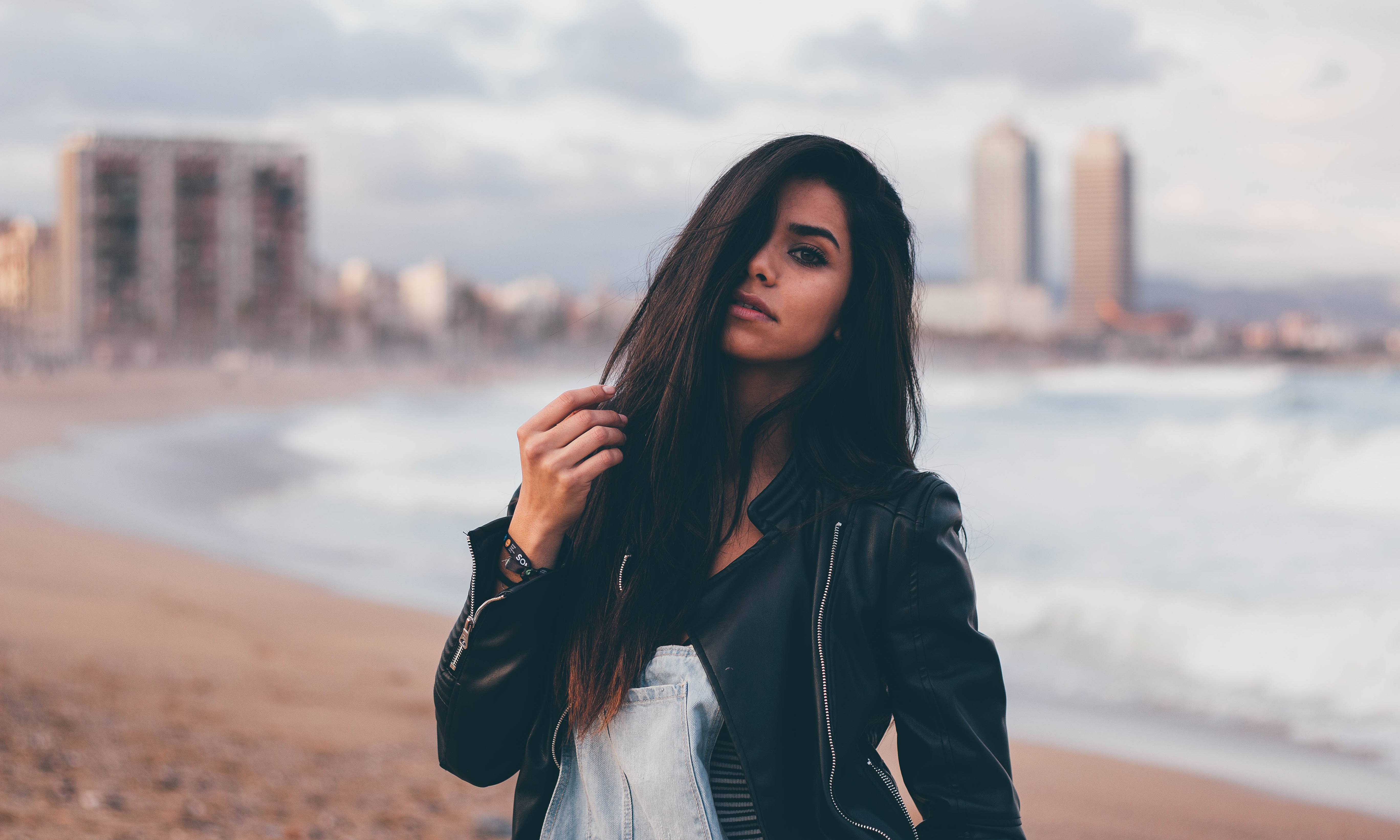 Woman with black hair on a beach HD Wallpaper