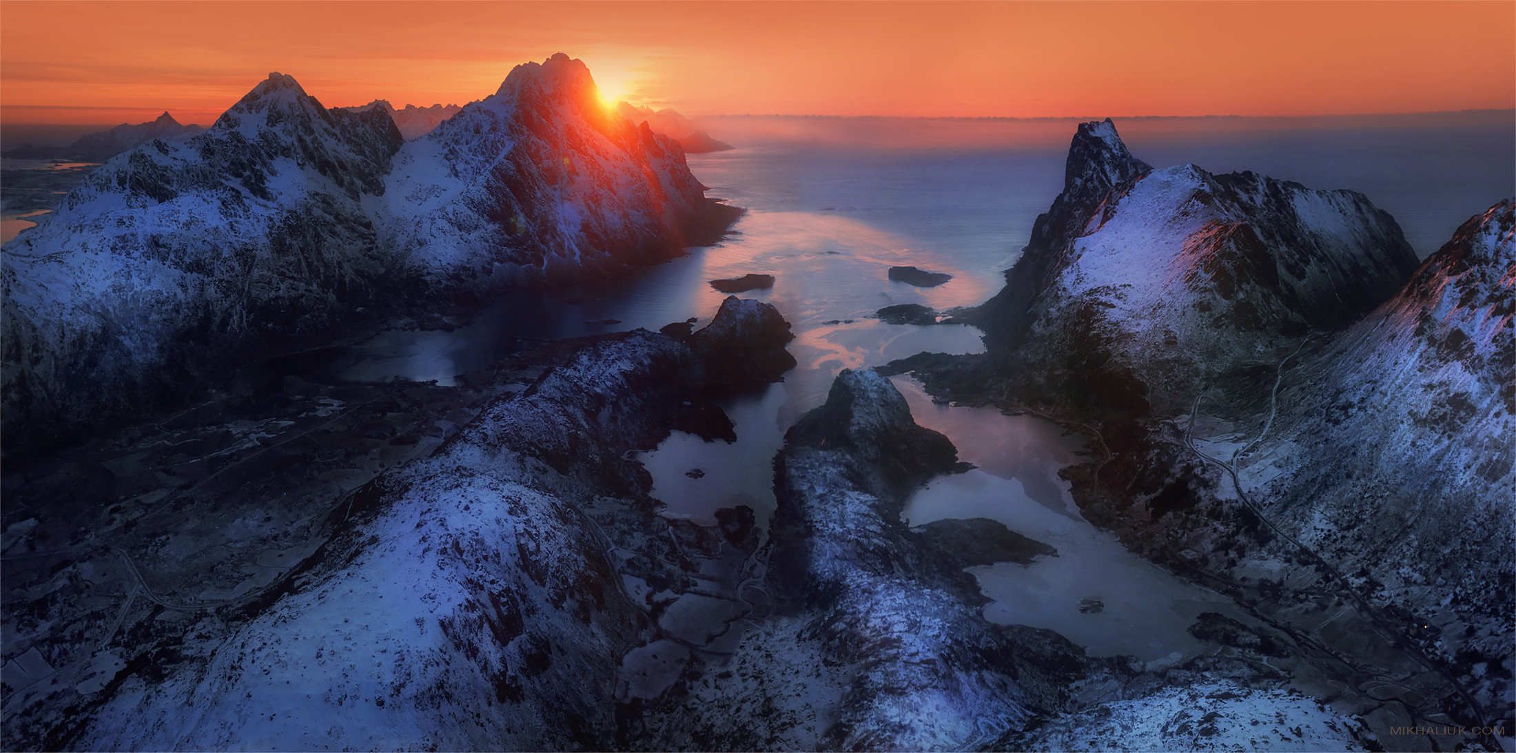 Snowy mountains at sunset over the ocean HD Wallpaper