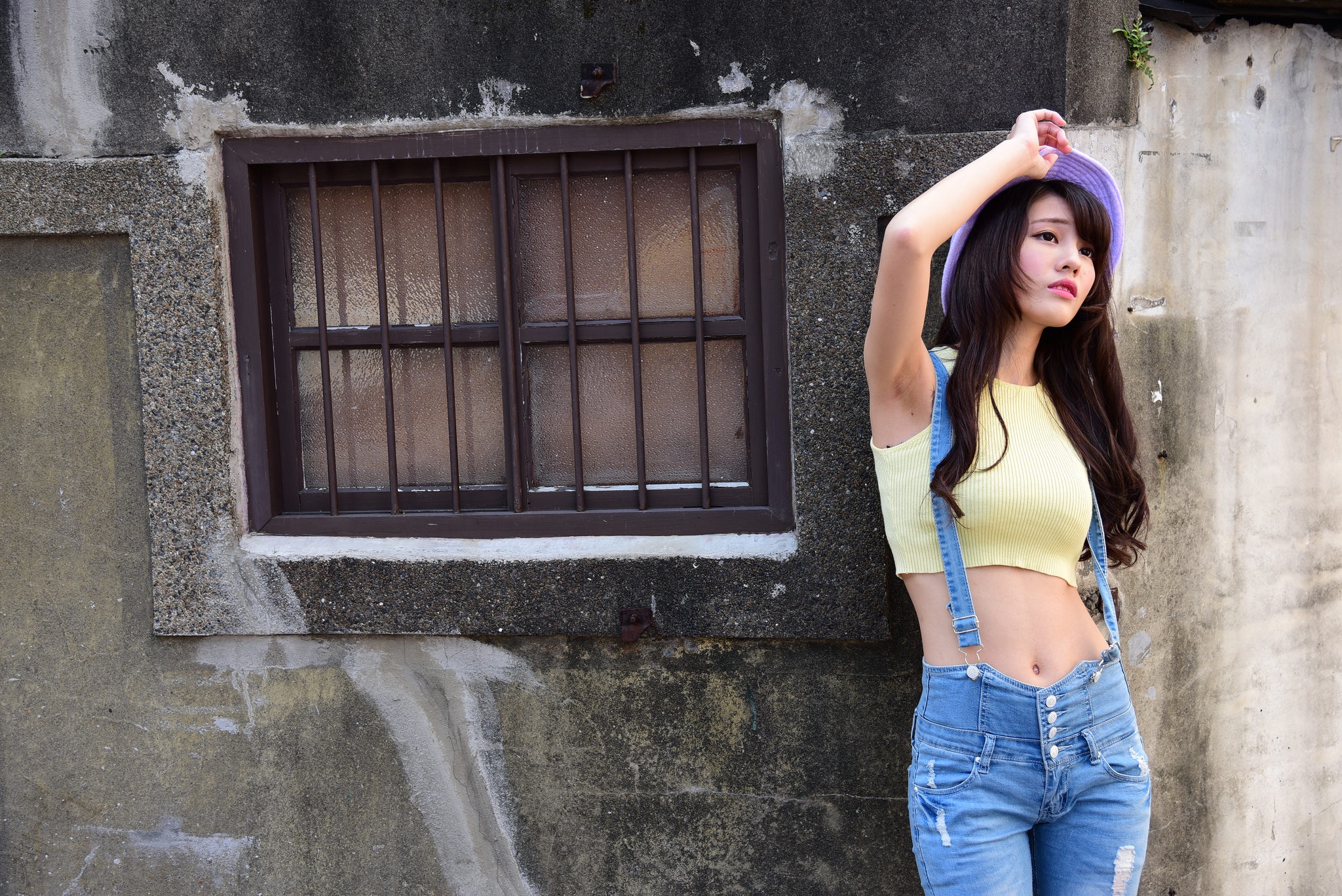 Asian woman with long hair wearing a yellow crop top and jeans HD Wallpaper