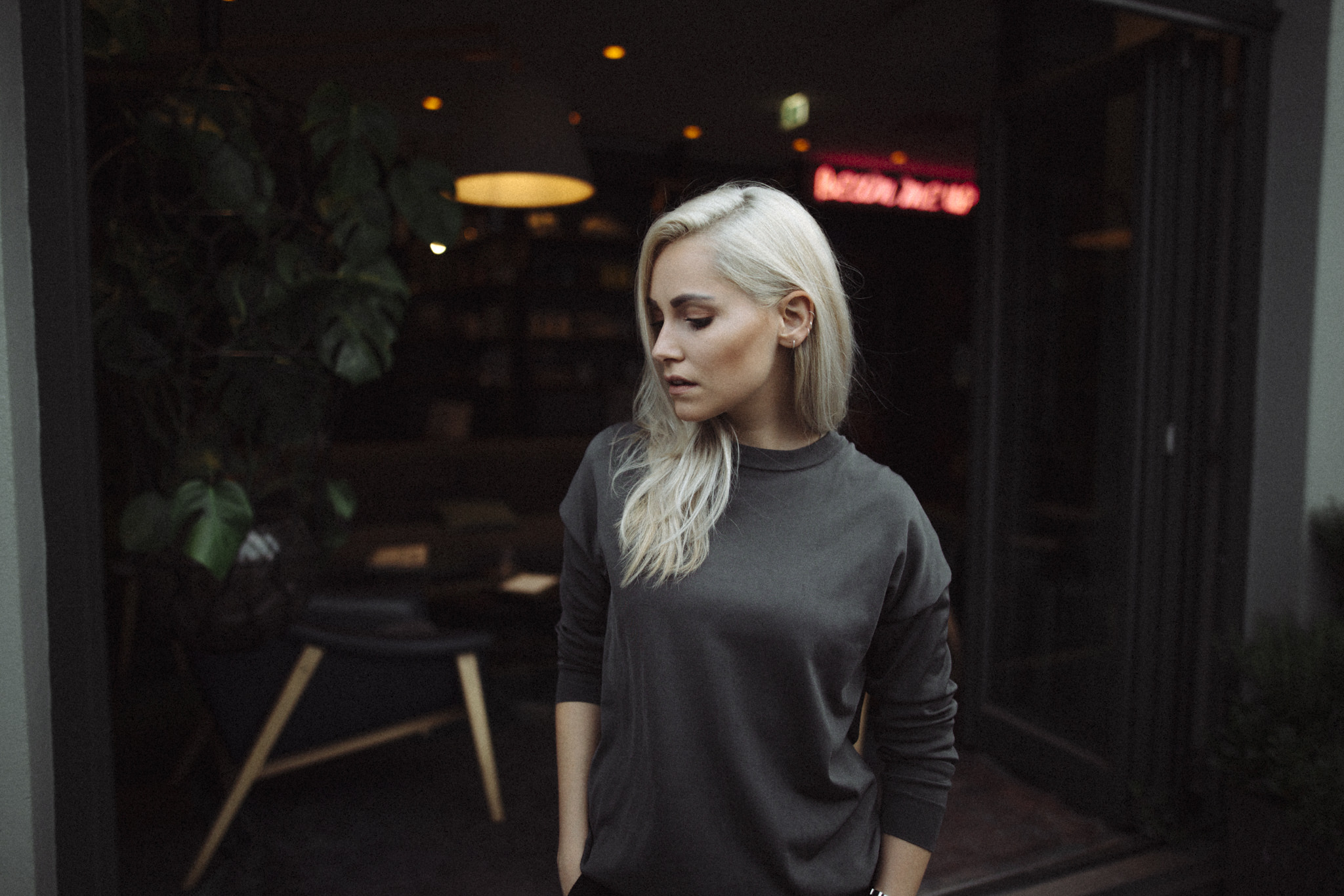 Woman with blonde hair in a dark sweater HD Wallpaper