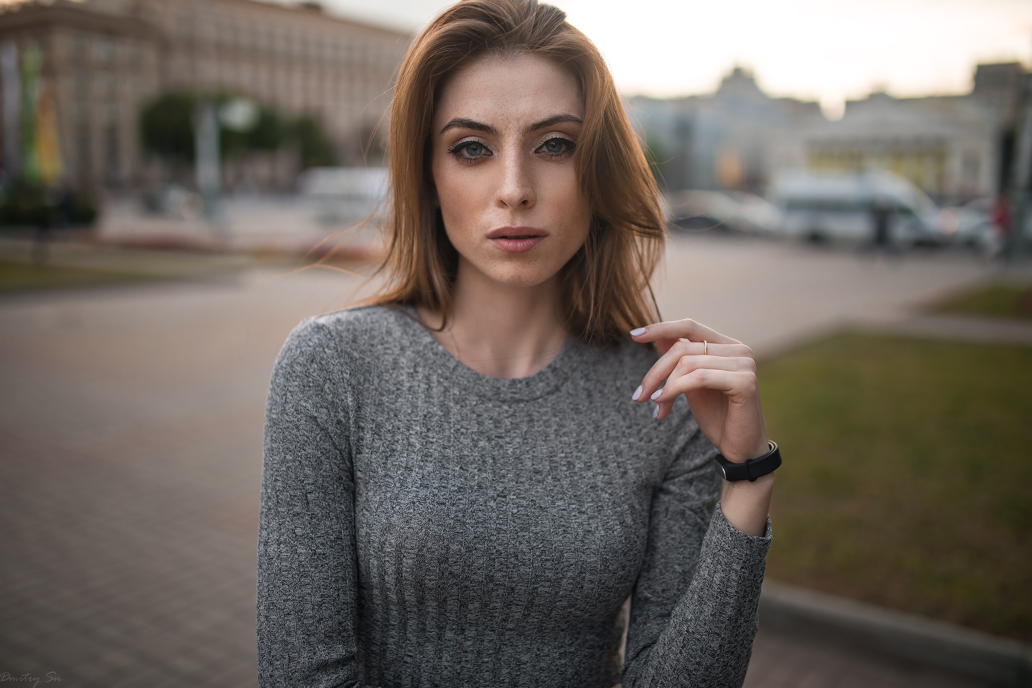 Woman with freckles in a grey sweater outdoors HD Wallpaper