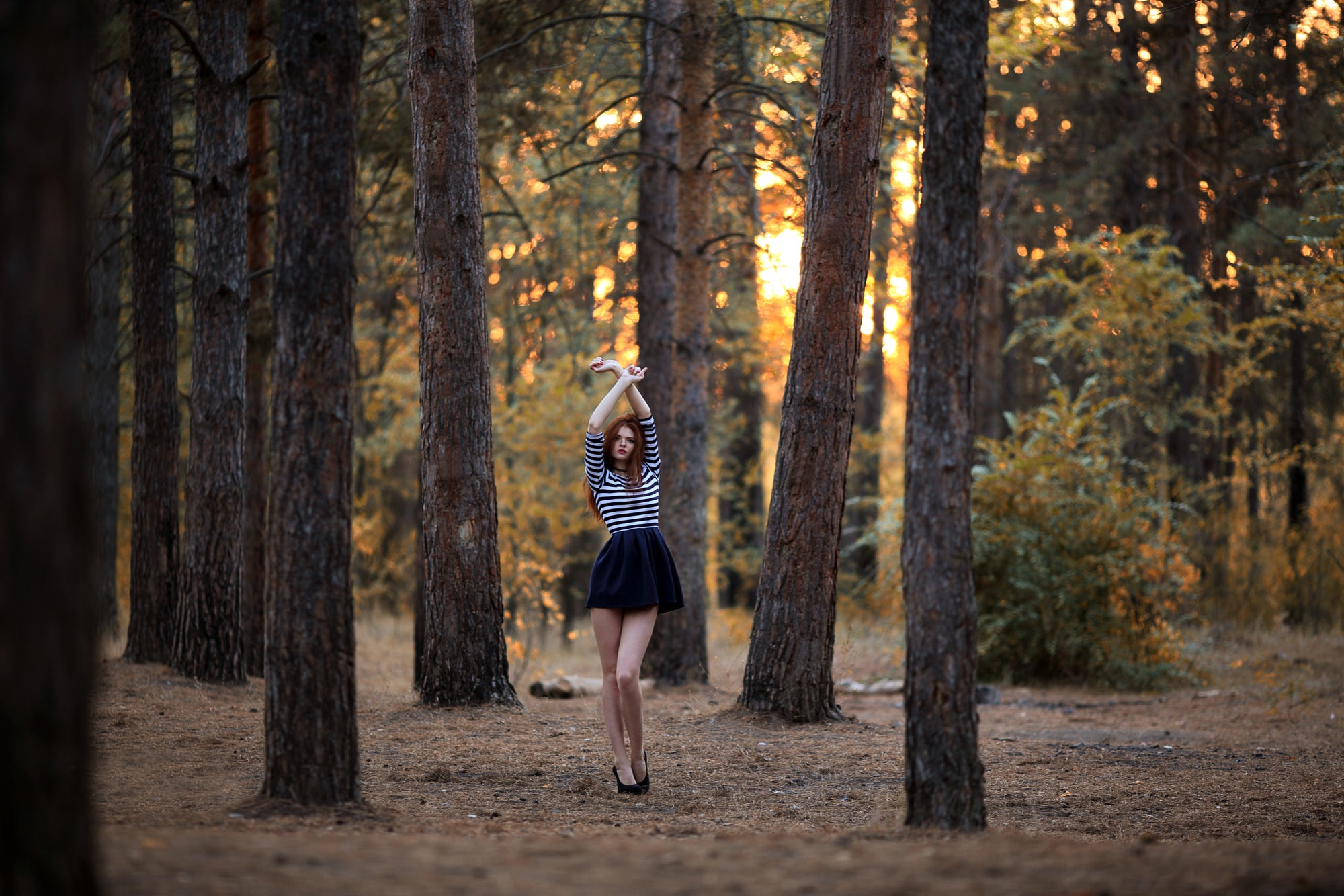 Redhead woman with arms up in a forest HD Wallpaper