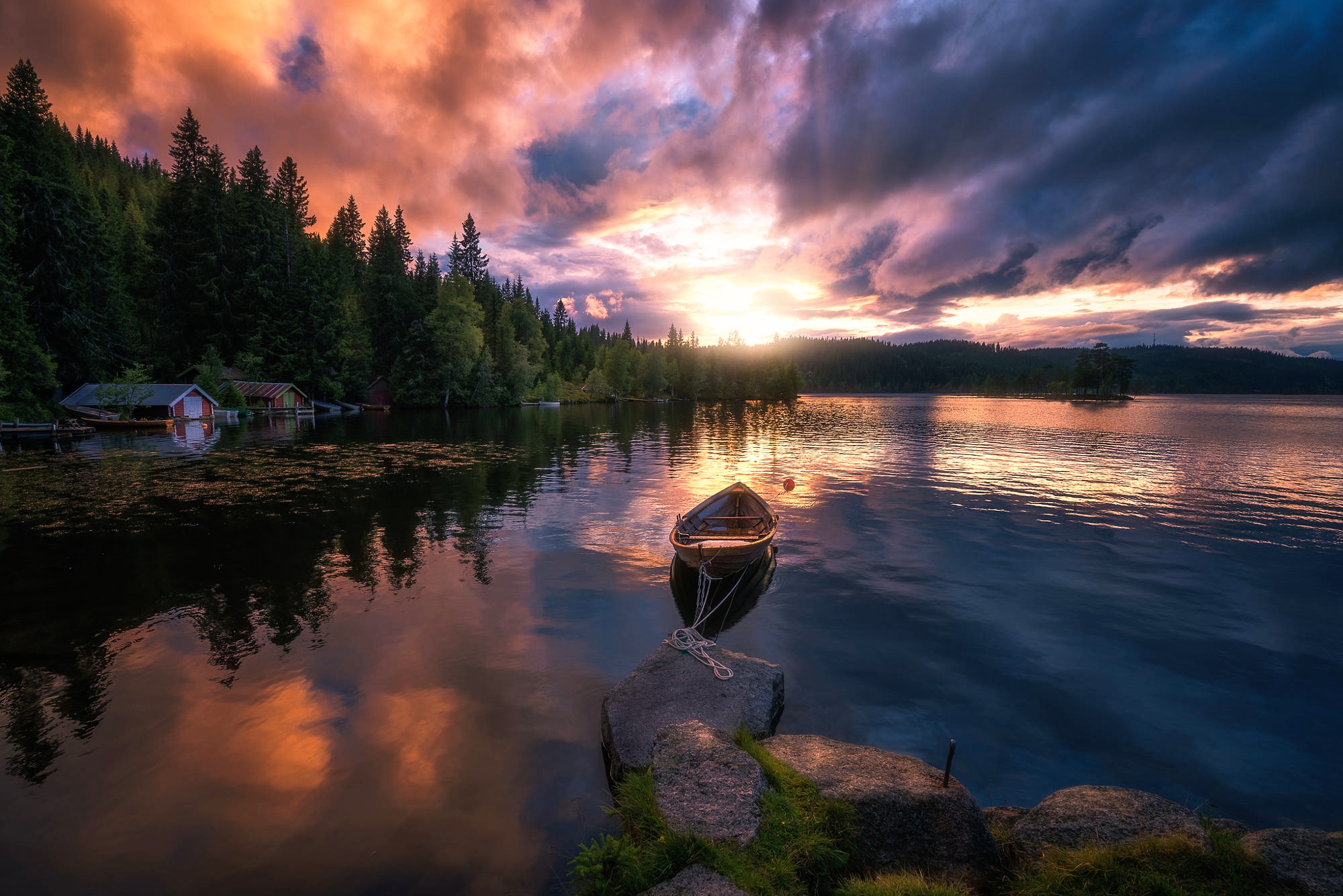 Boat on a lake at sunset with colorful clouds HD Wallpaper