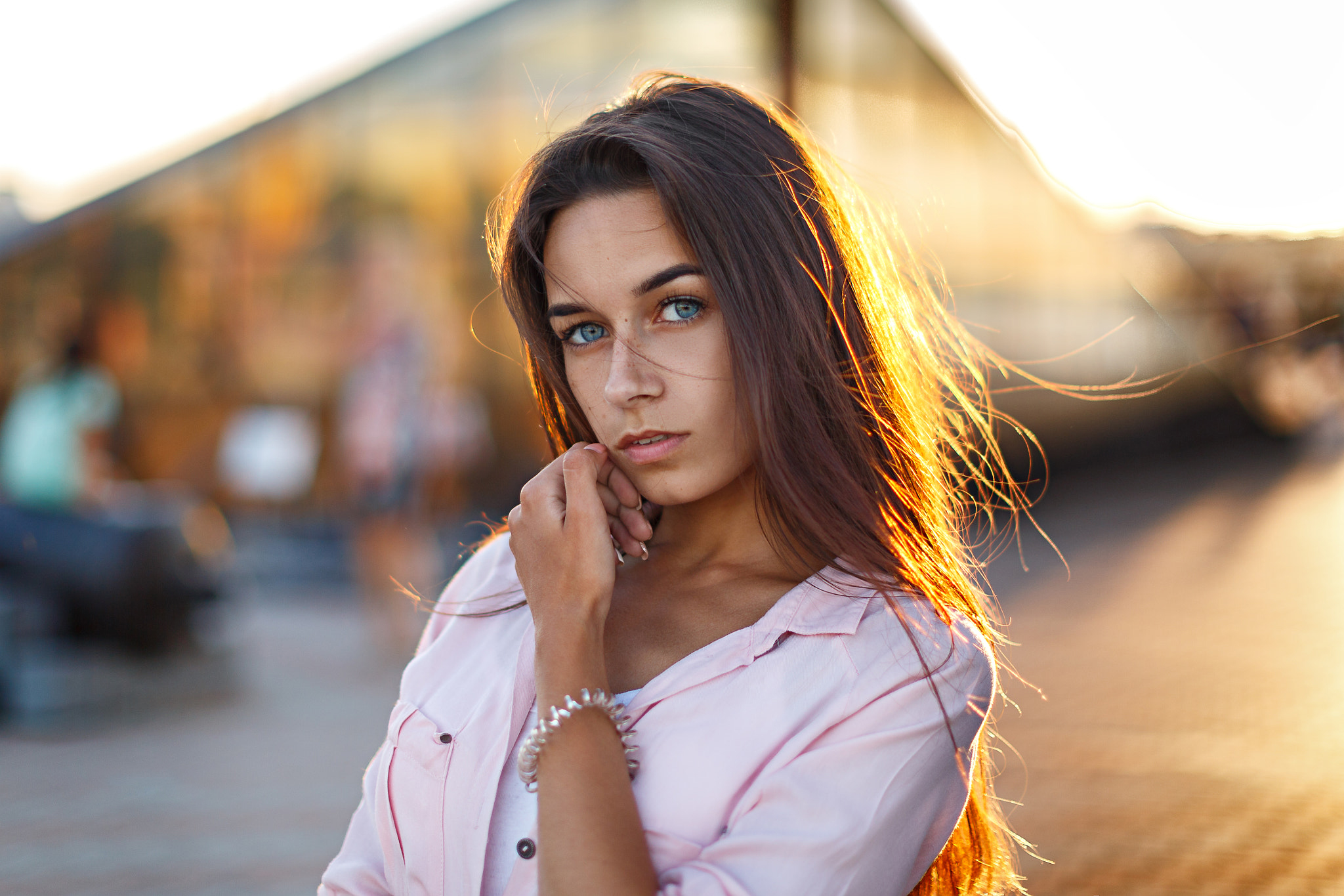 Woman with blue eyes in a pink shirt outdoors HD Wallpaper