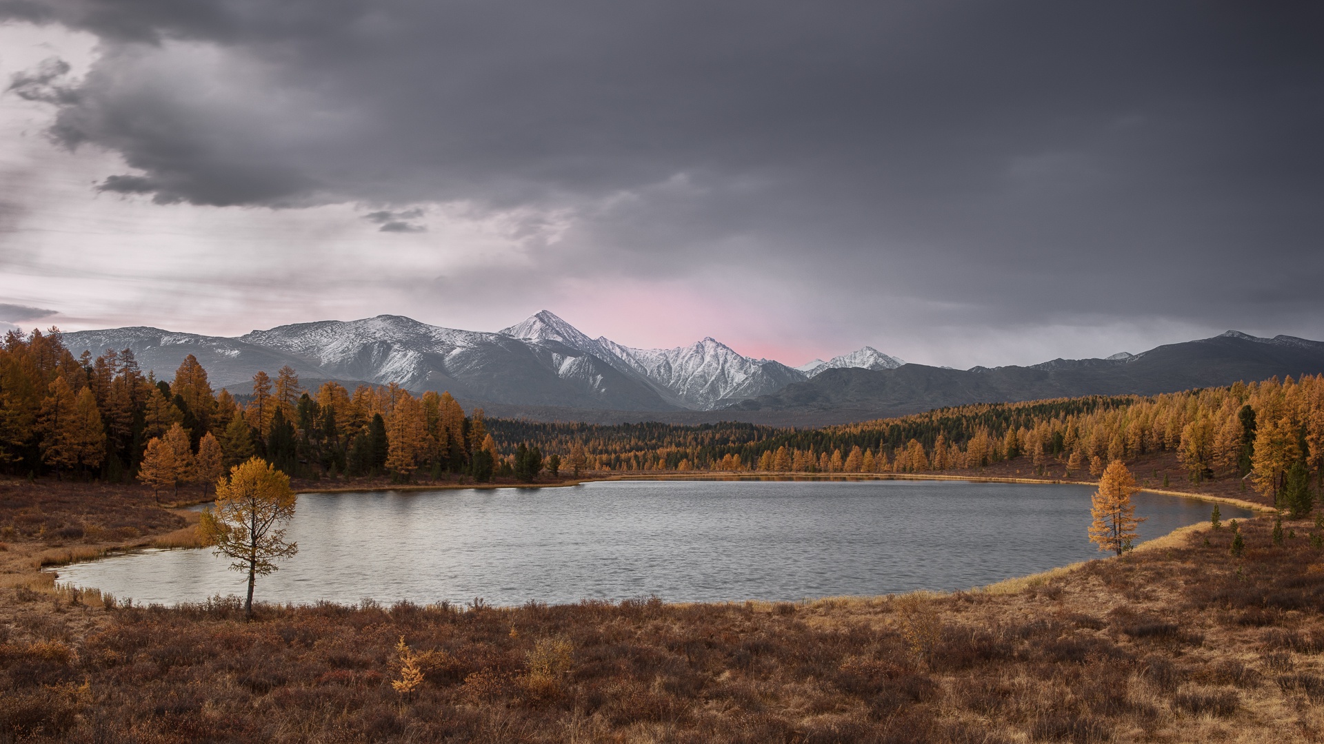 Autumn lake with snow-capped mountains and dark clouds HD Wallpaper