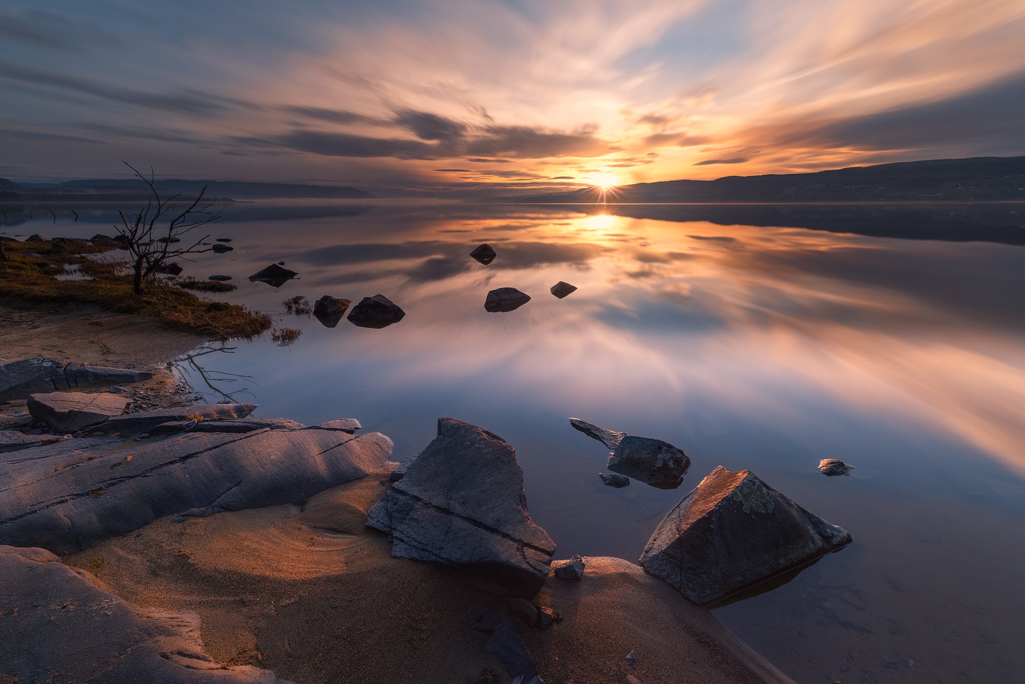 Sunset over a calm lake with rocks in Norway HD Wallpaper