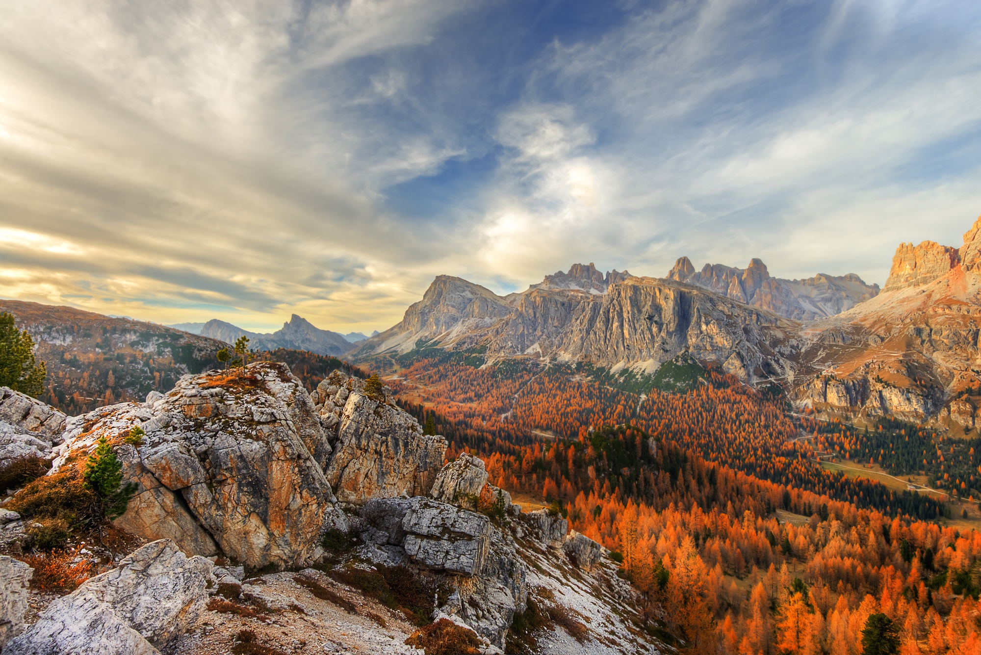 Autumn forest in the Dolomites mountains under a cloudy sky HD Wallpaper