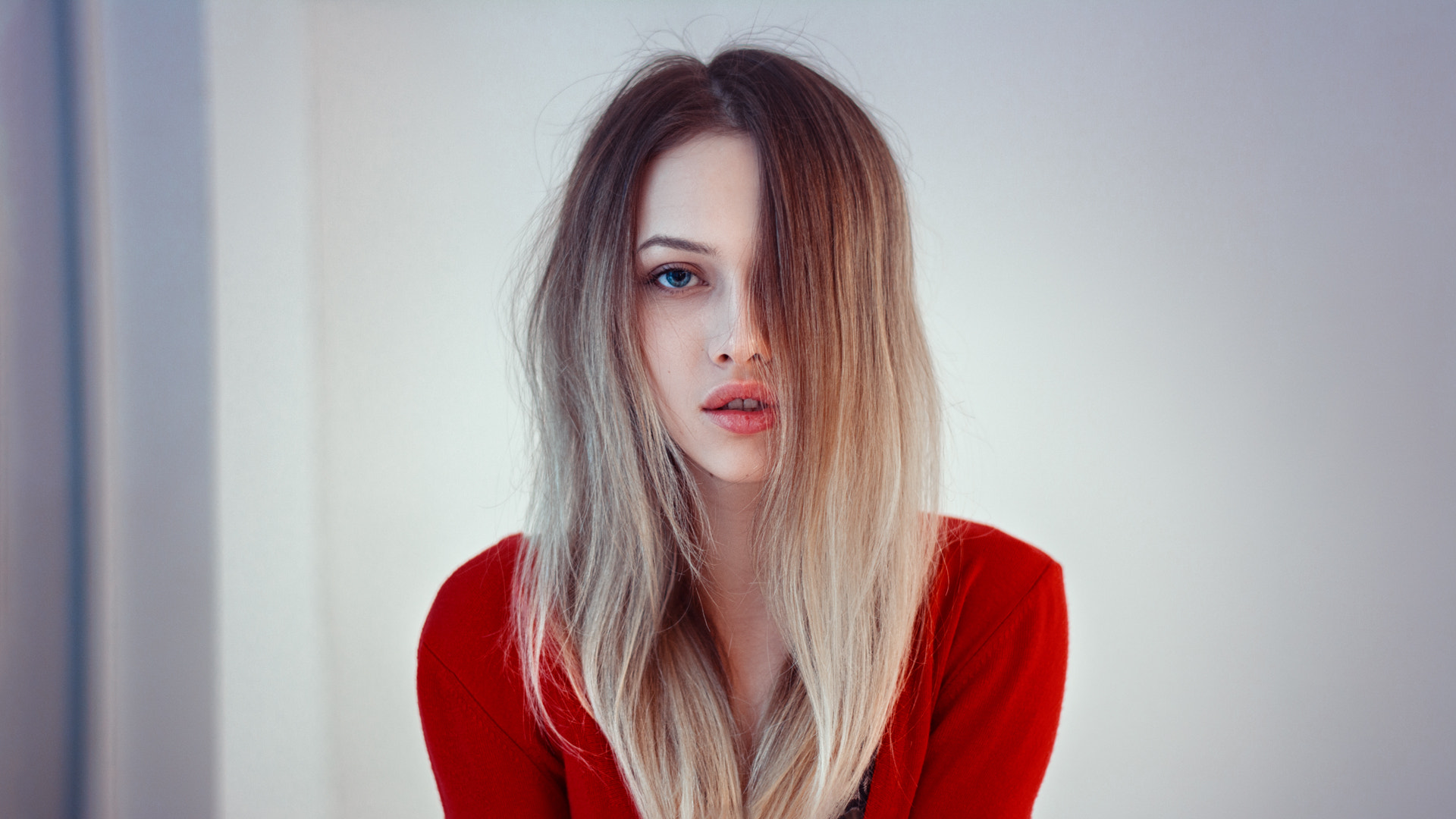 Woman with blonde hair and blue eyes in red clothing HD Wallpaper