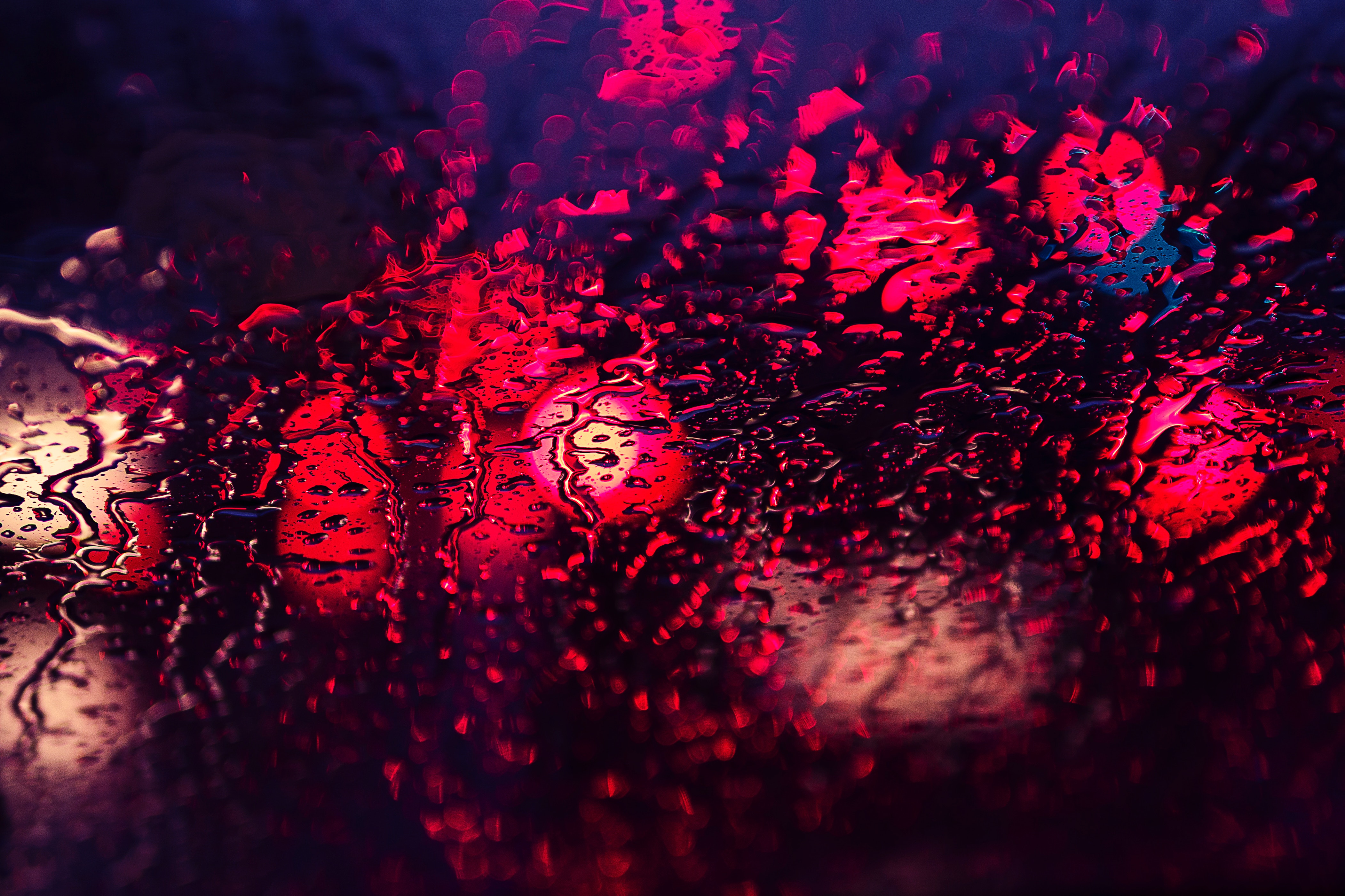 Red lights and water drops on a window HD Wallpaper