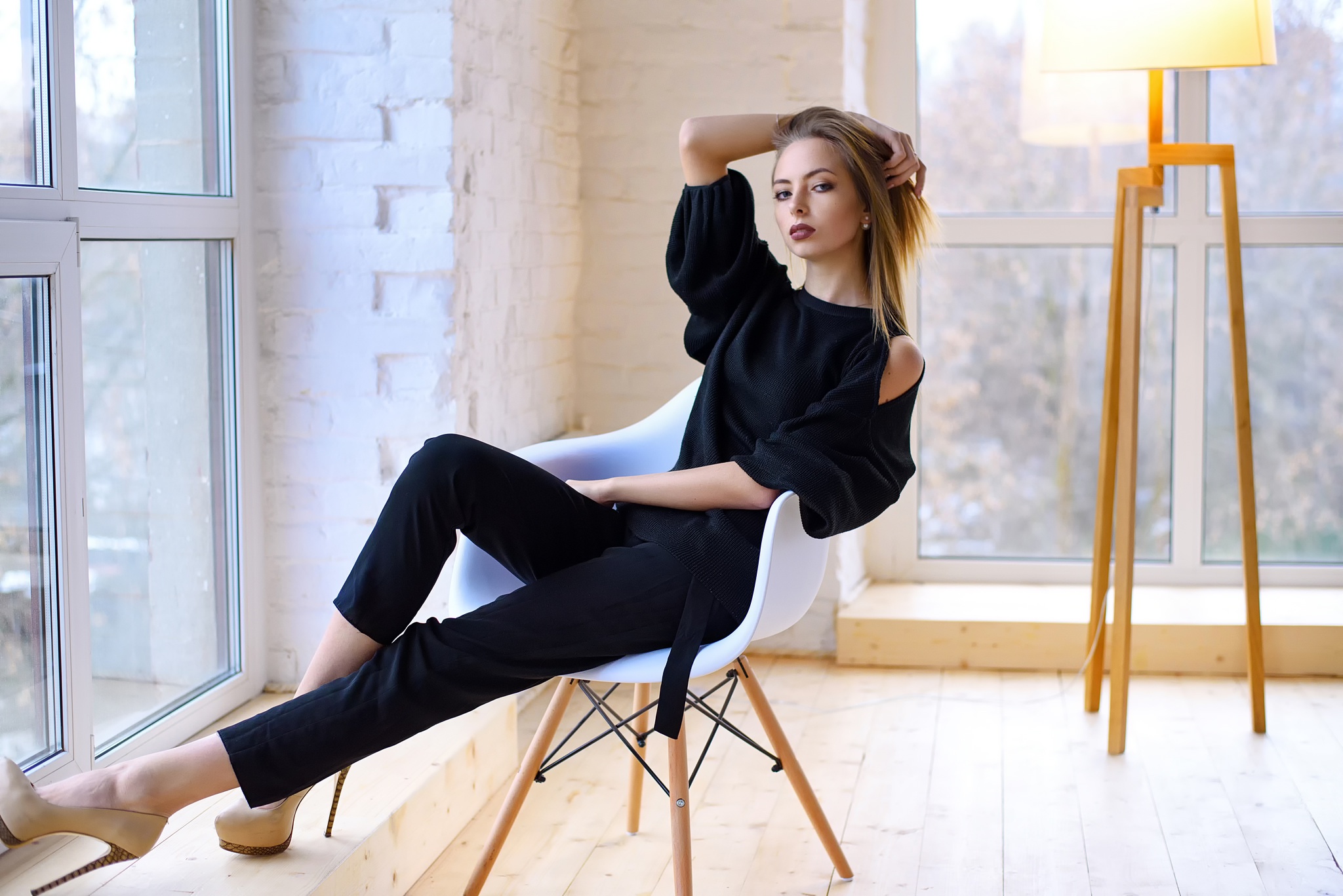 Woman in black clothing sitting in a chair HD Wallpaper