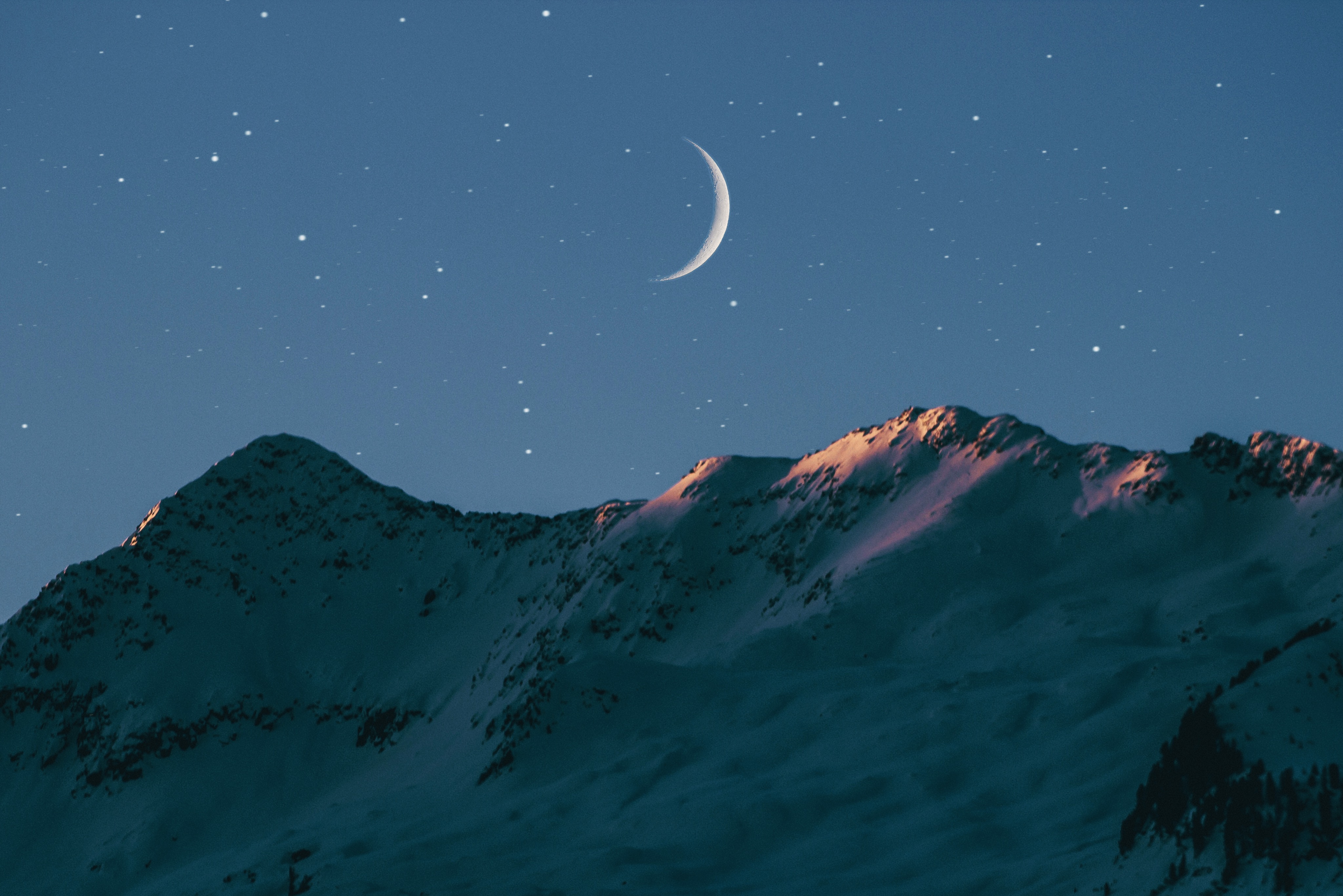 Crescent moon over snow-capped mountains under a starry sky HD Wallpaper