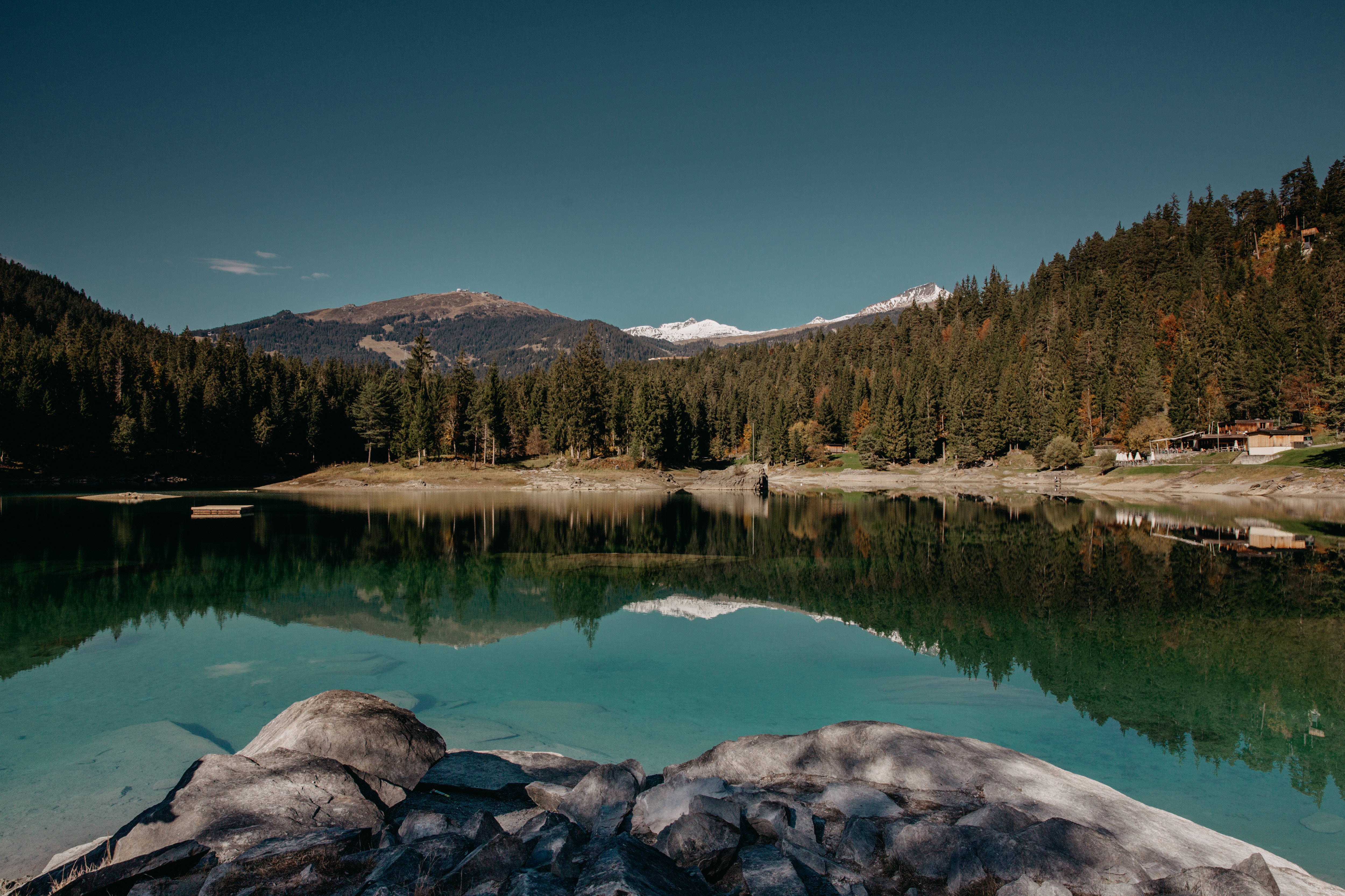 Lake reflection with forest and mountains in Switzerland HD Wallpaper