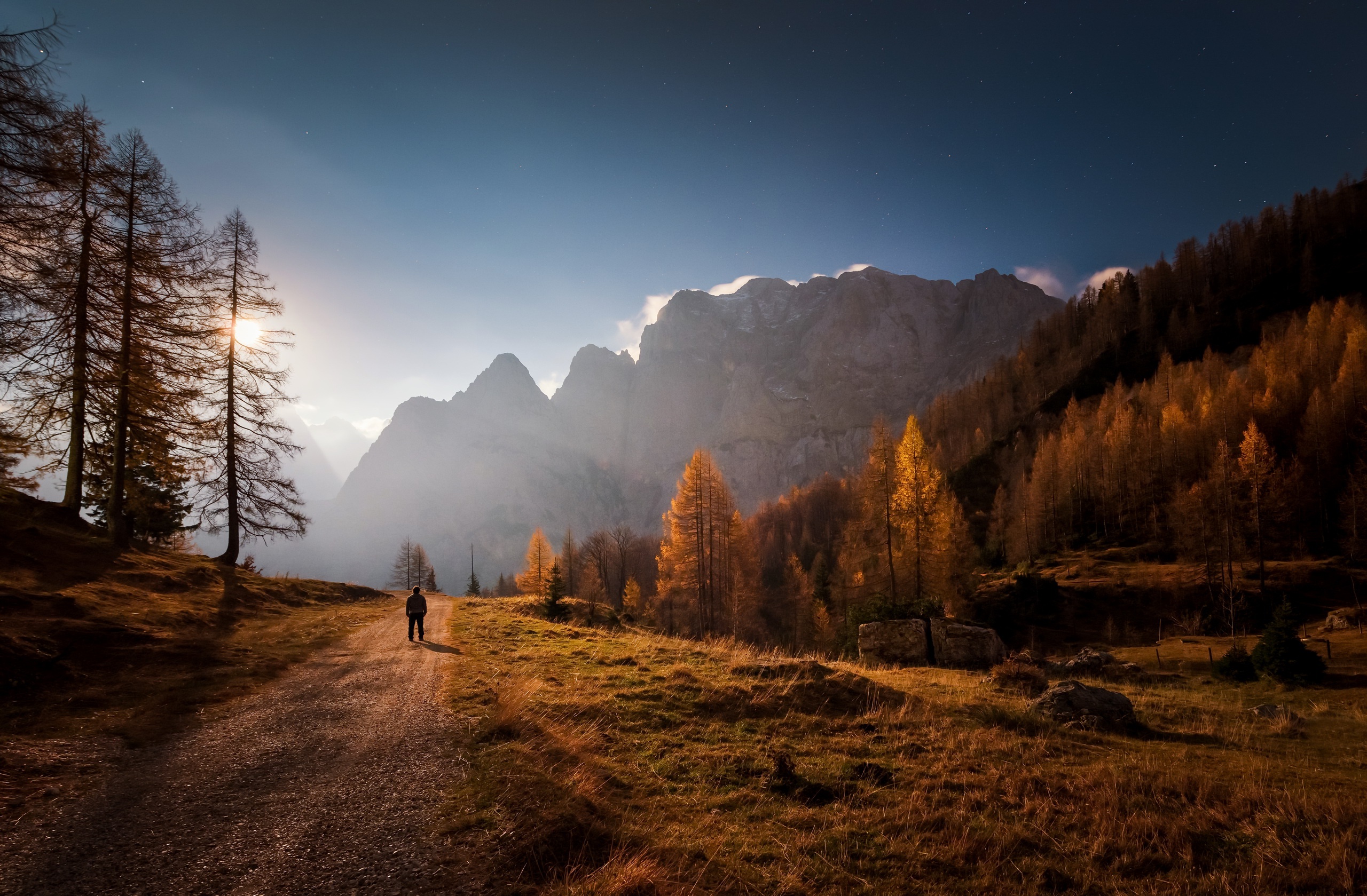Man walking on a path in the mountains during fall HD Wallpaper