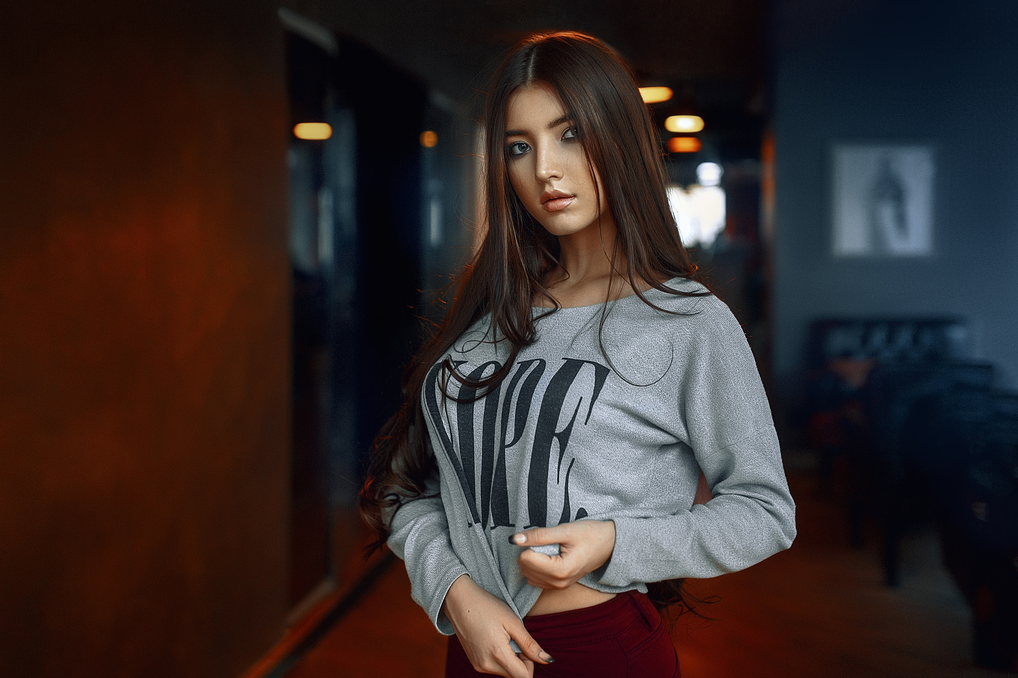 Woman with long brown hair wearing a grey sweatshirt HD Wallpaper
