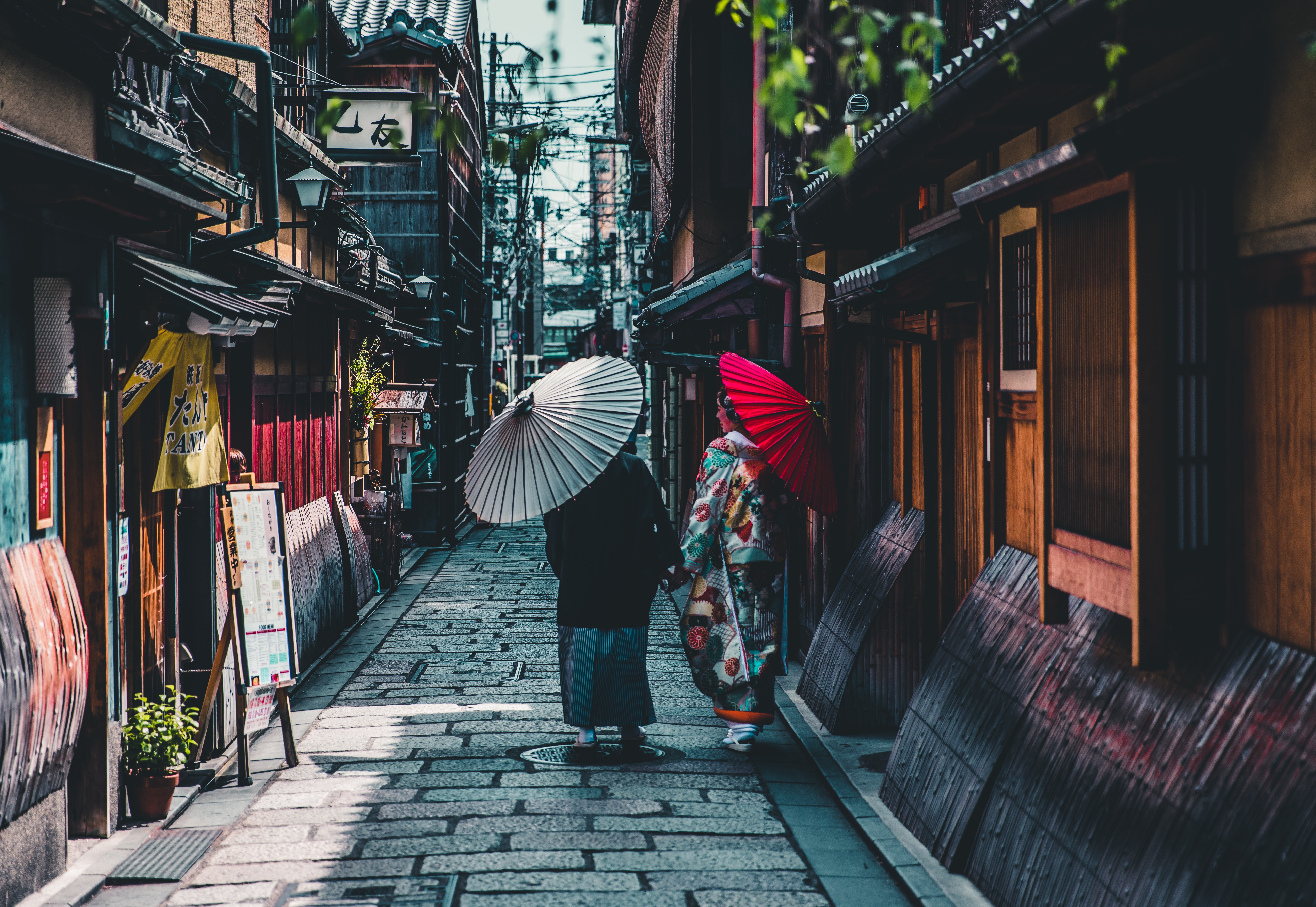 Two people with umbrellas on a Japanese street HD Wallpaper
