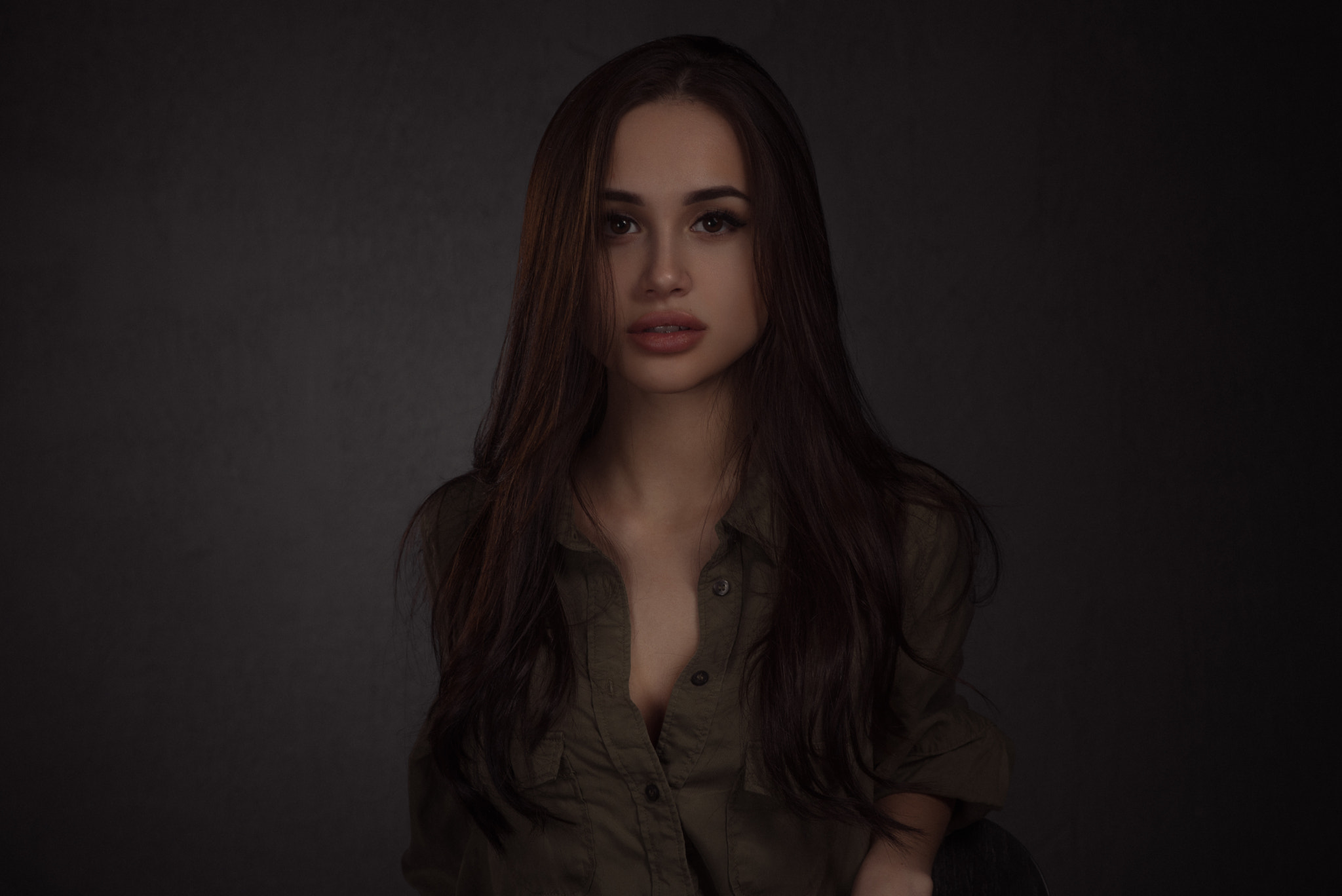 Woman in a green shirt with long brown hair HD Wallpaper