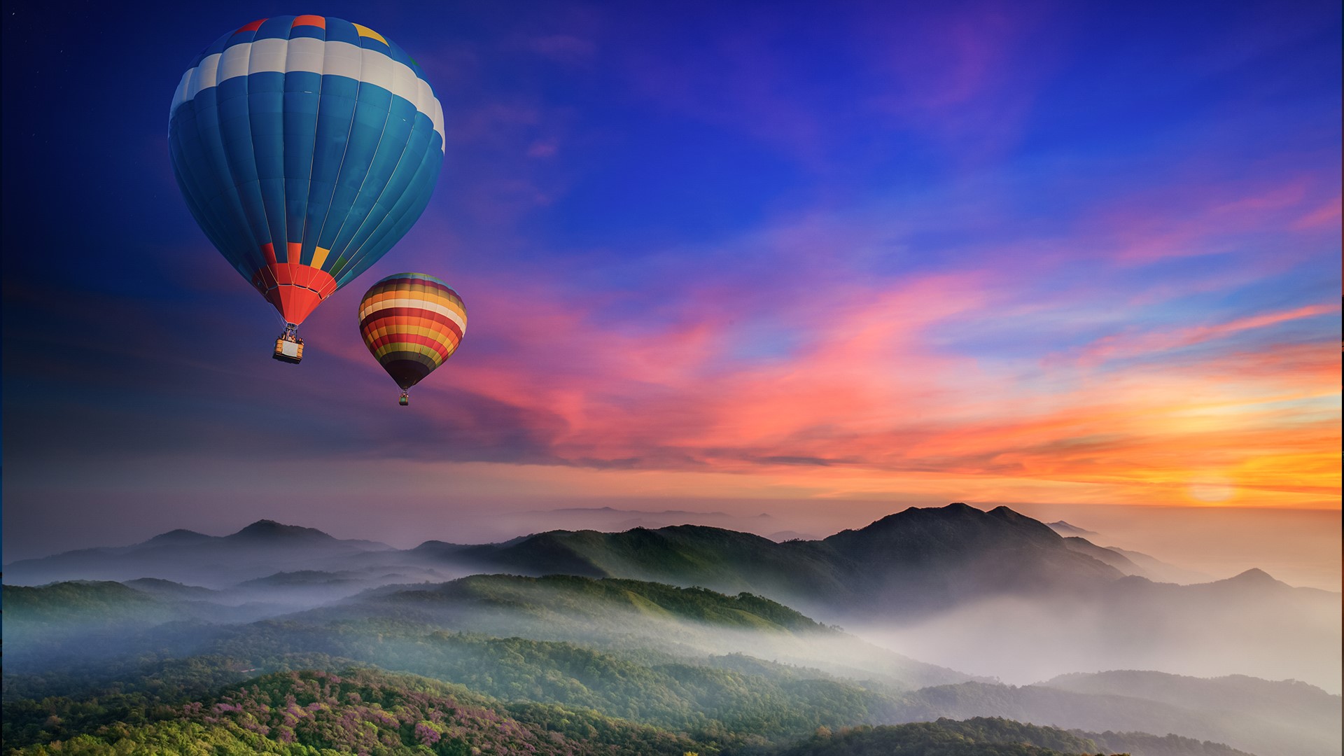 Hot air balloons over misty mountains at sunset HD Wallpaper