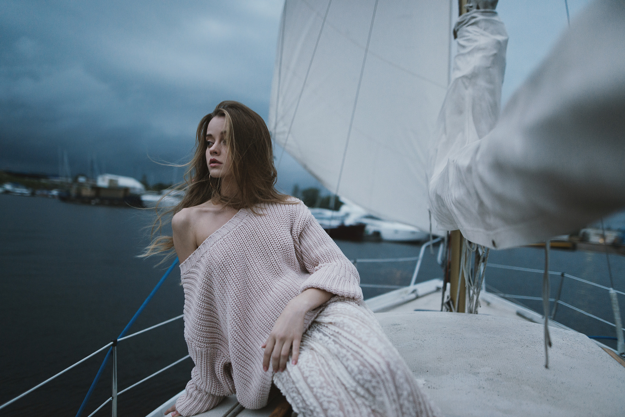 Woman on a sailboat with stormy skies HD Wallpaper