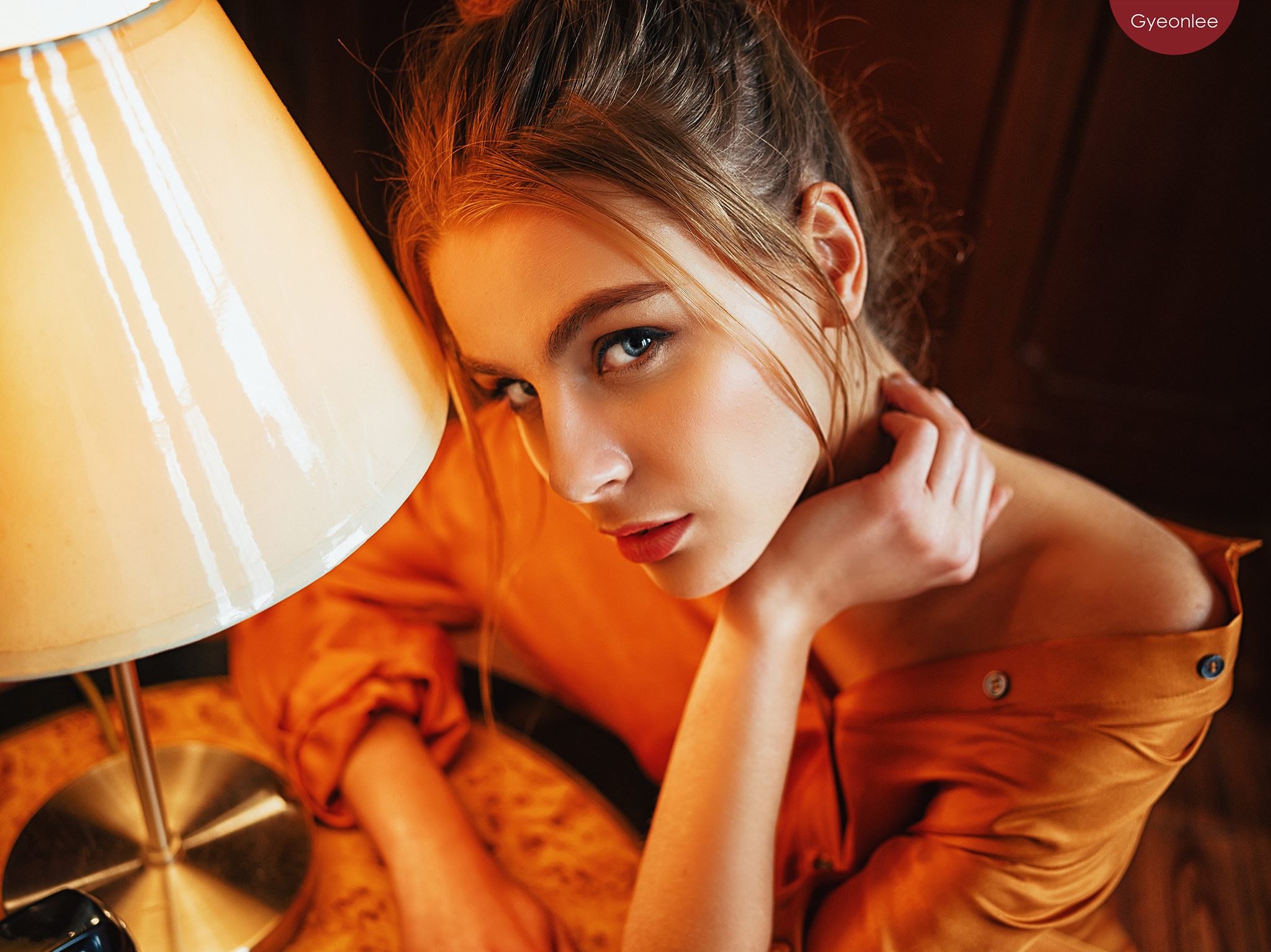 Woman in orange shirt near a lamp HD Wallpaper