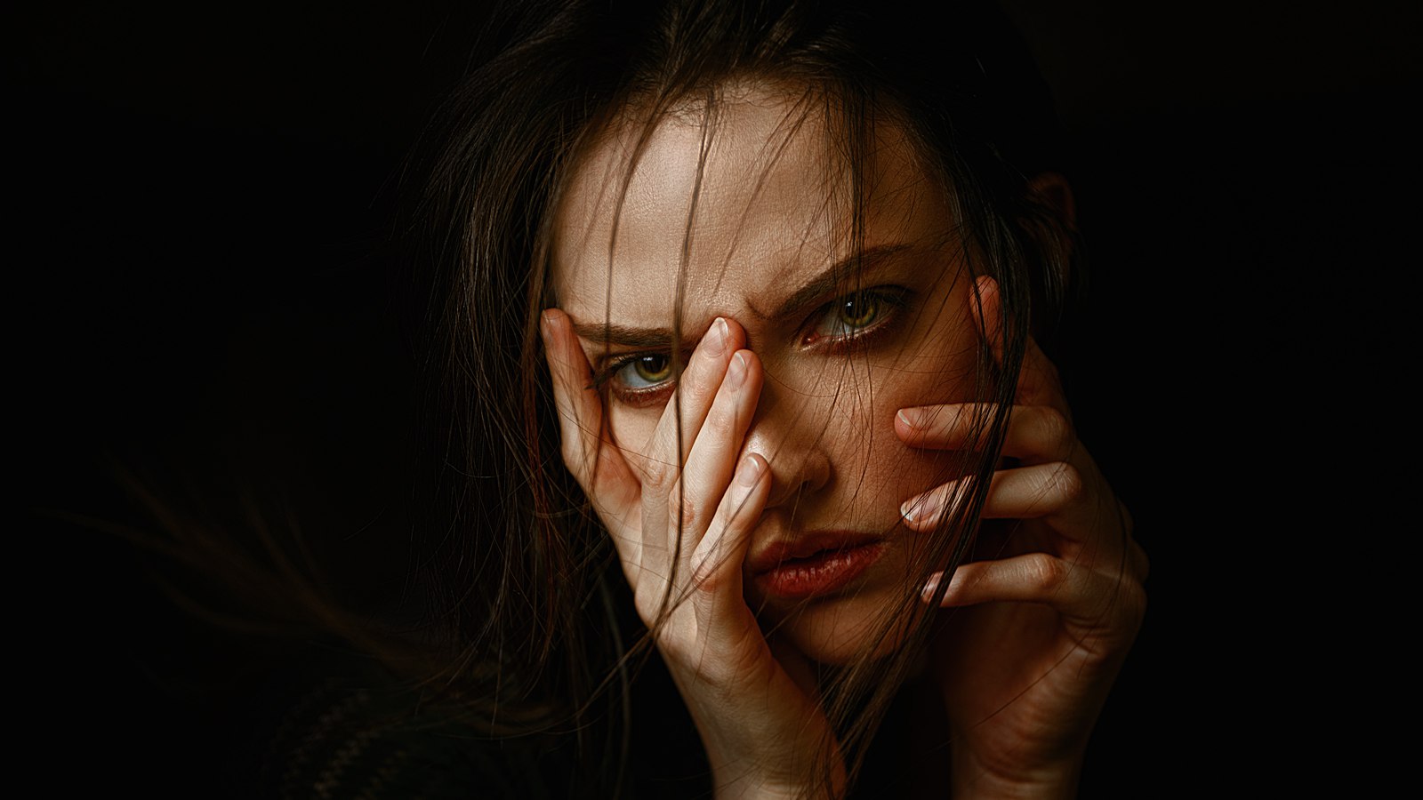 Portrait of a woman with hands covering her face HD Wallpaper