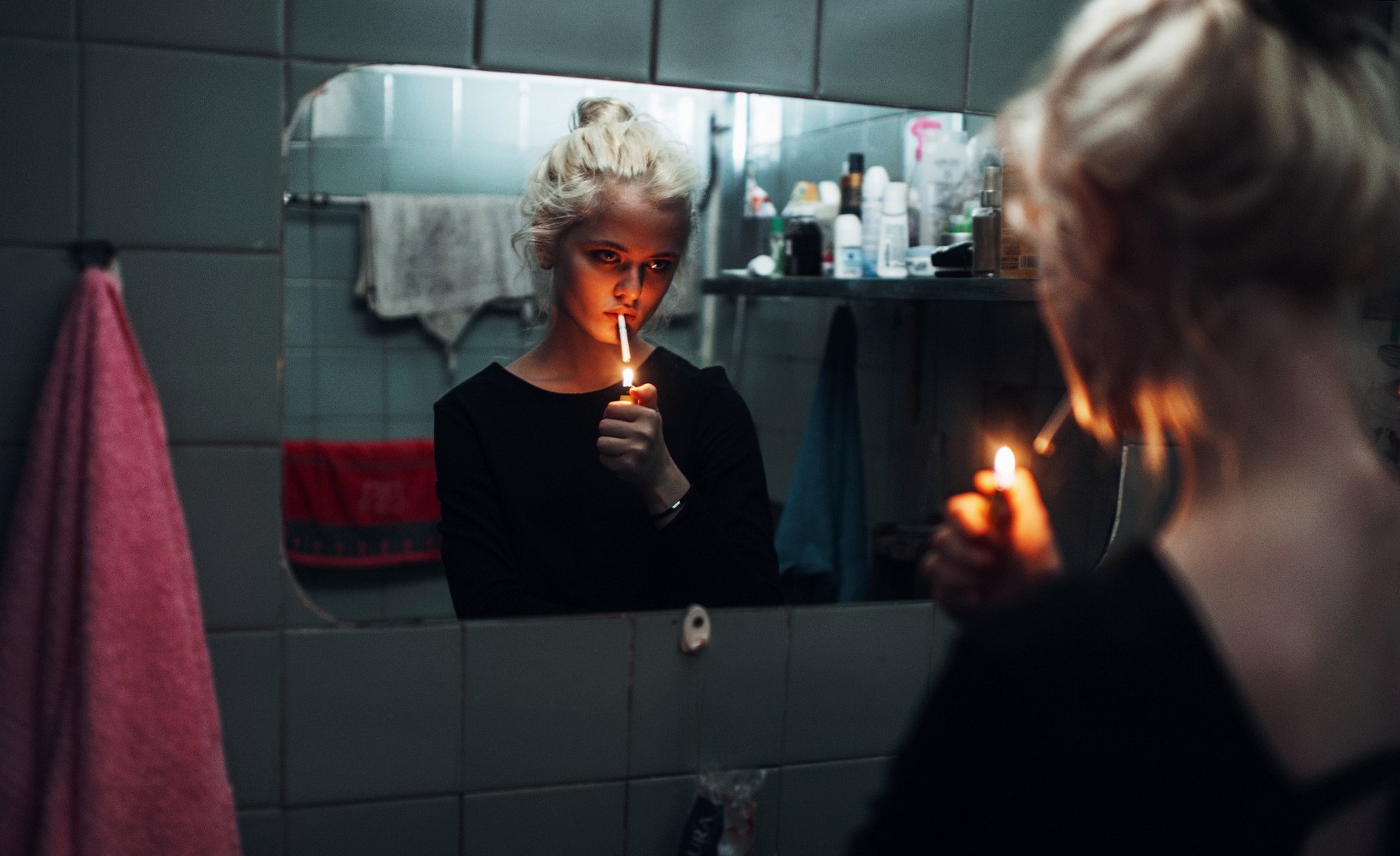 Woman lighting cigarette in bathroom mirror HD Wallpaper