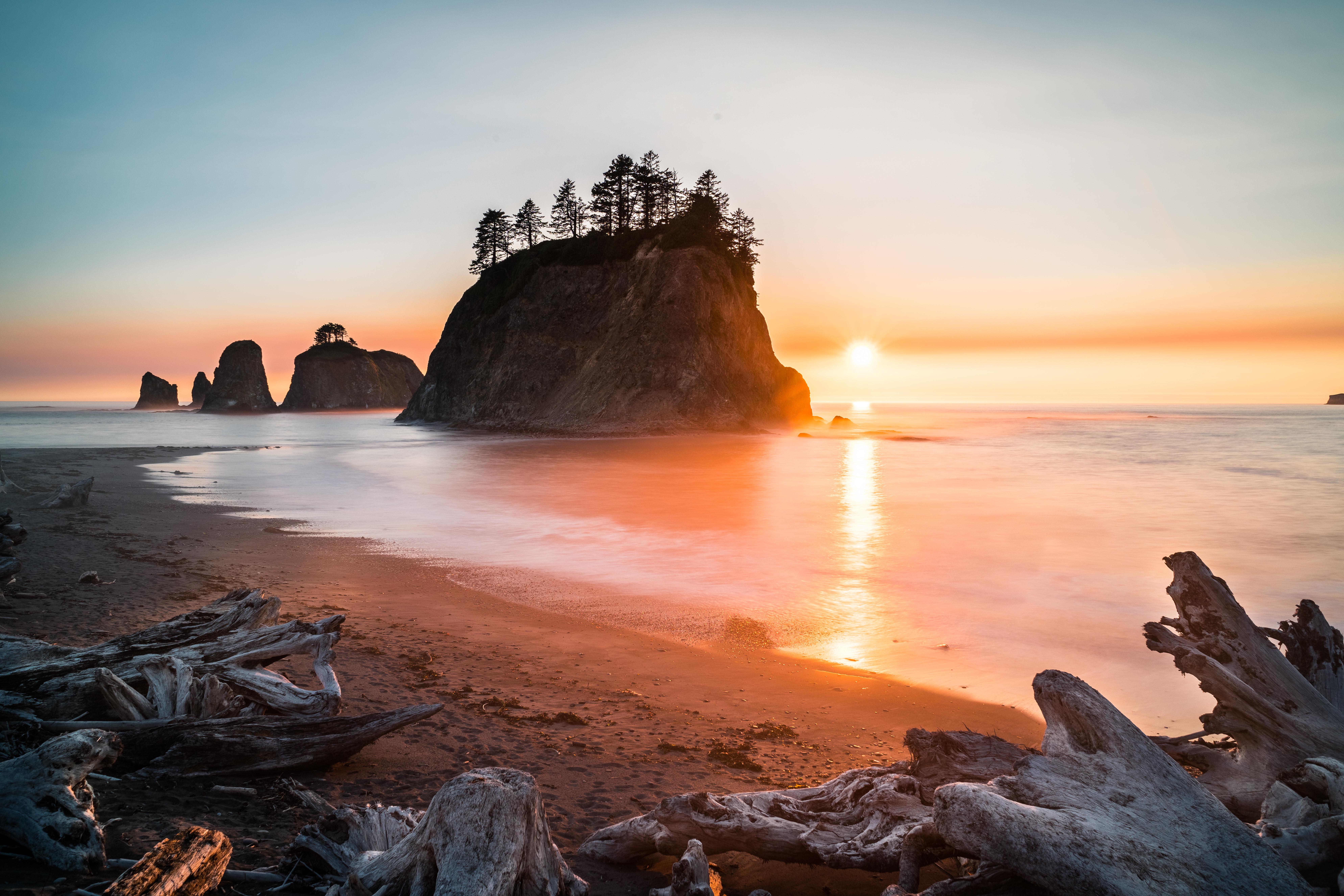 Sunset over Rialto Beach with sea stacks and driftwood HD Wallpaper
