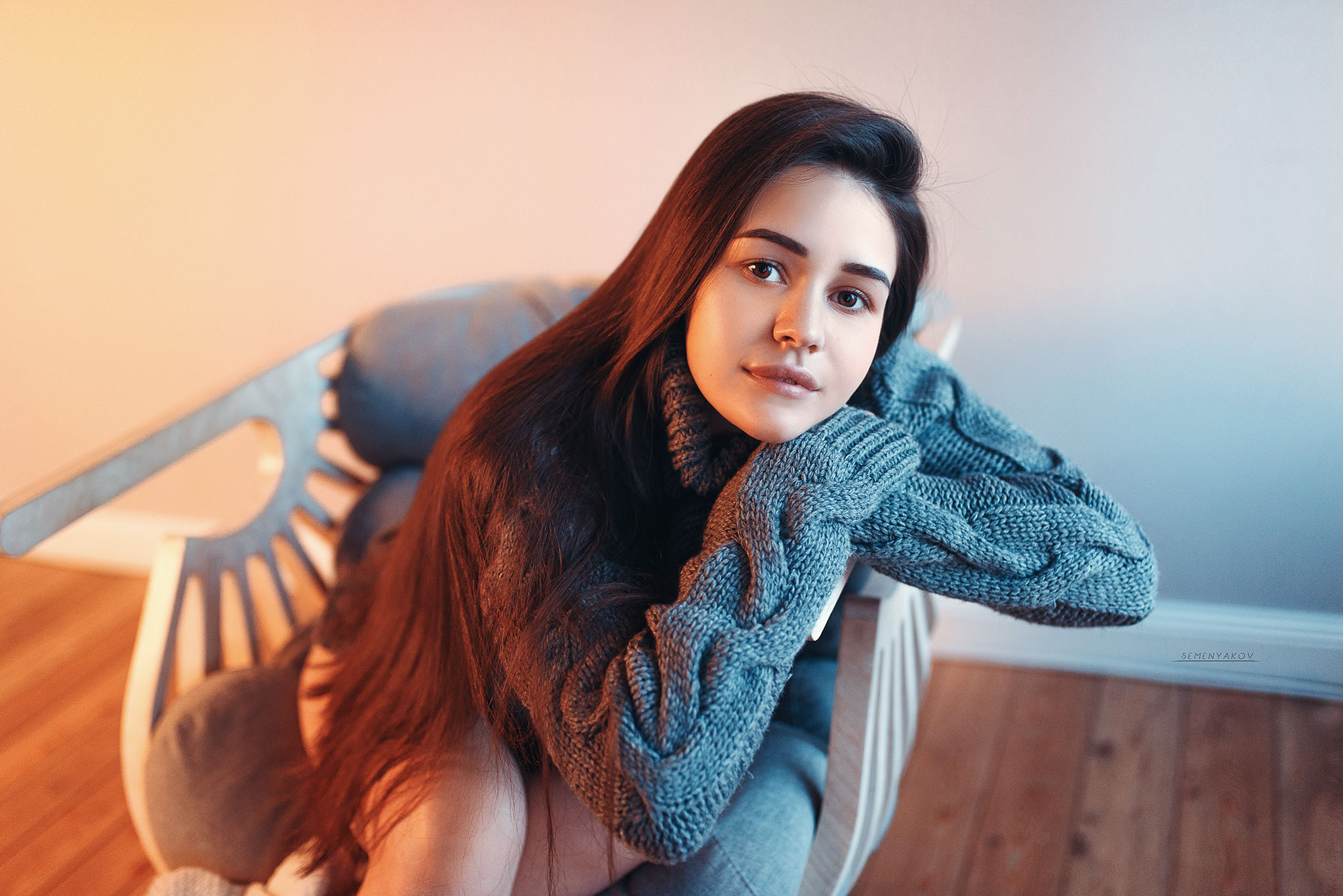 Woman in a gray sweater sitting in a chair HD Wallpaper