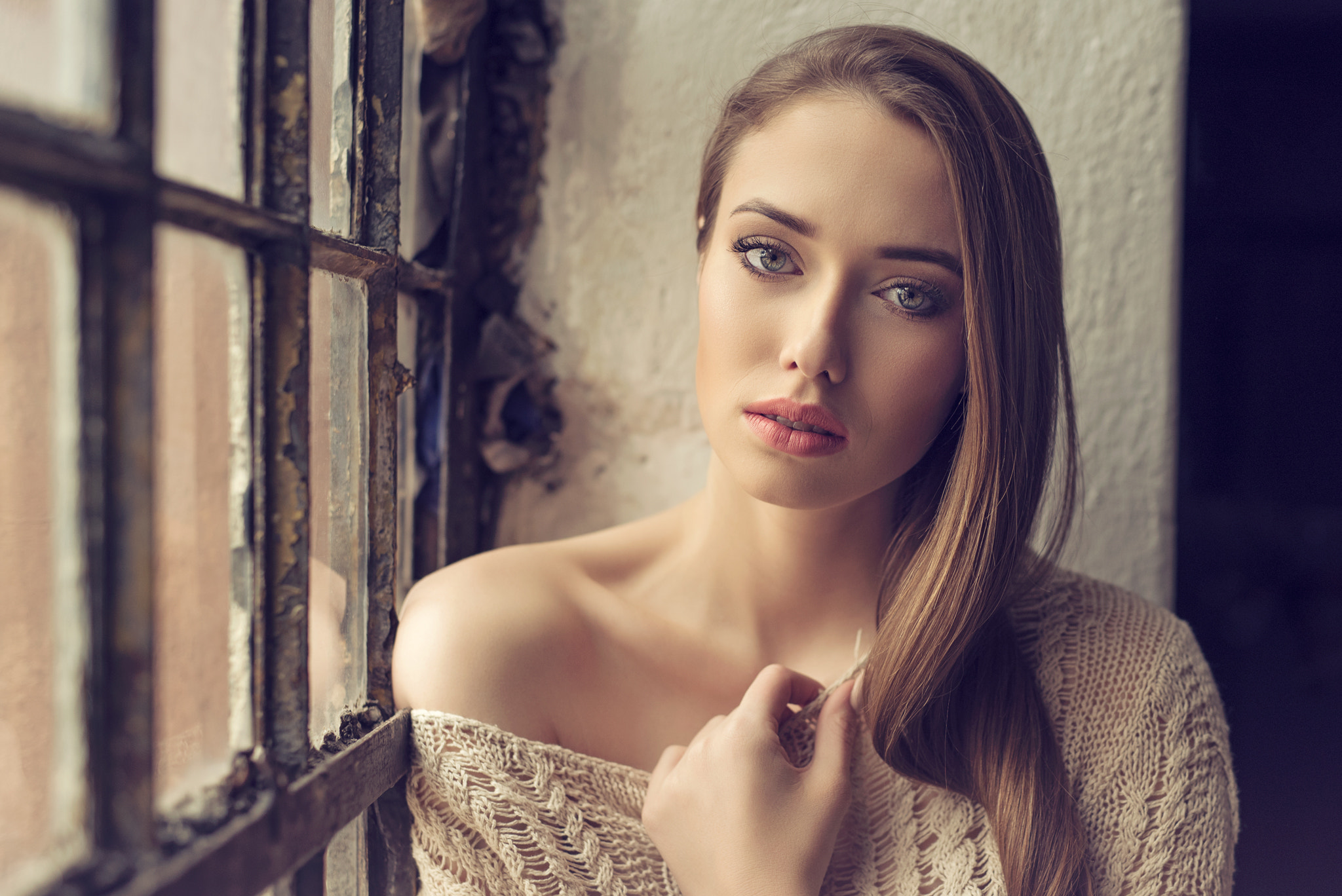 Woman in sweater by a window HD Wallpaper