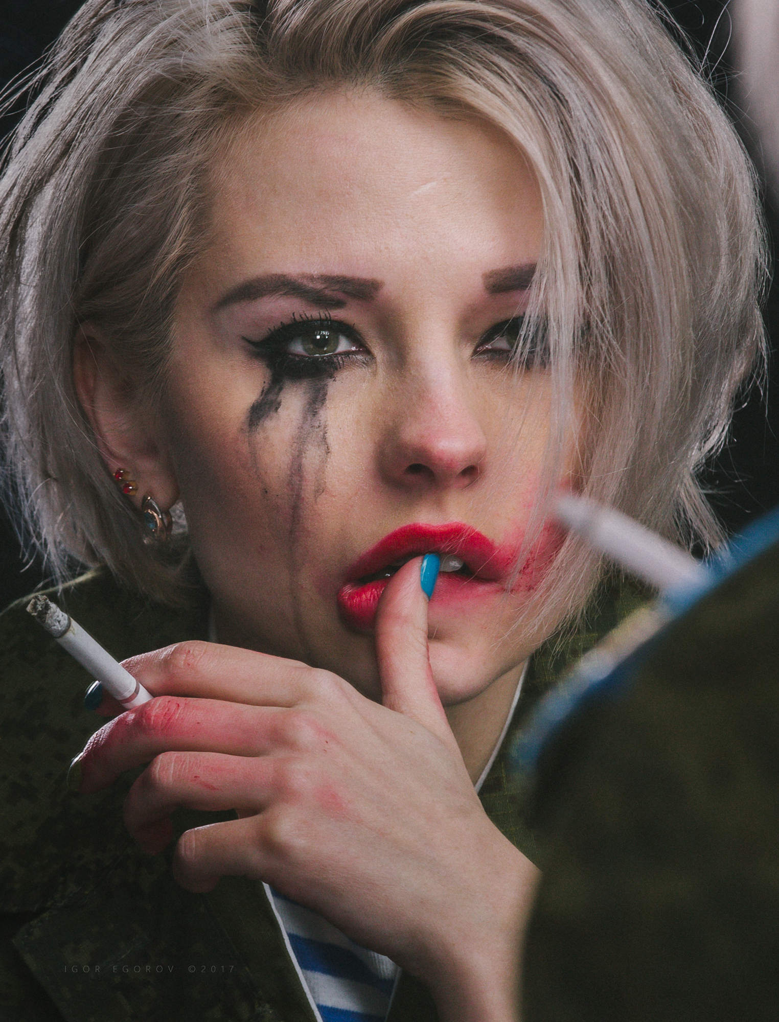 Woman with smudged makeup smoking a cigarette HD Wallpaper