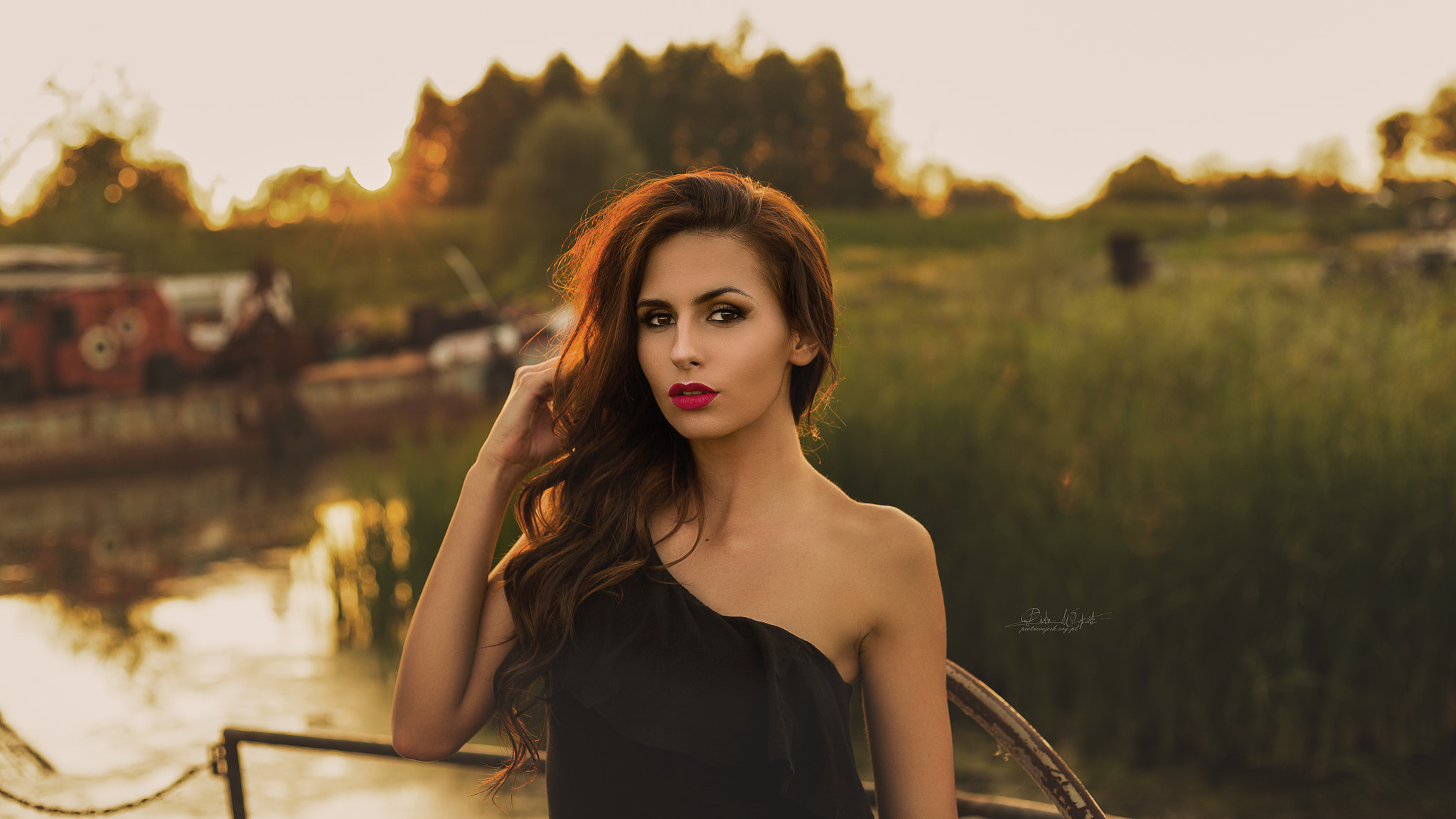Woman with red lipstick outdoors by water HD Wallpaper