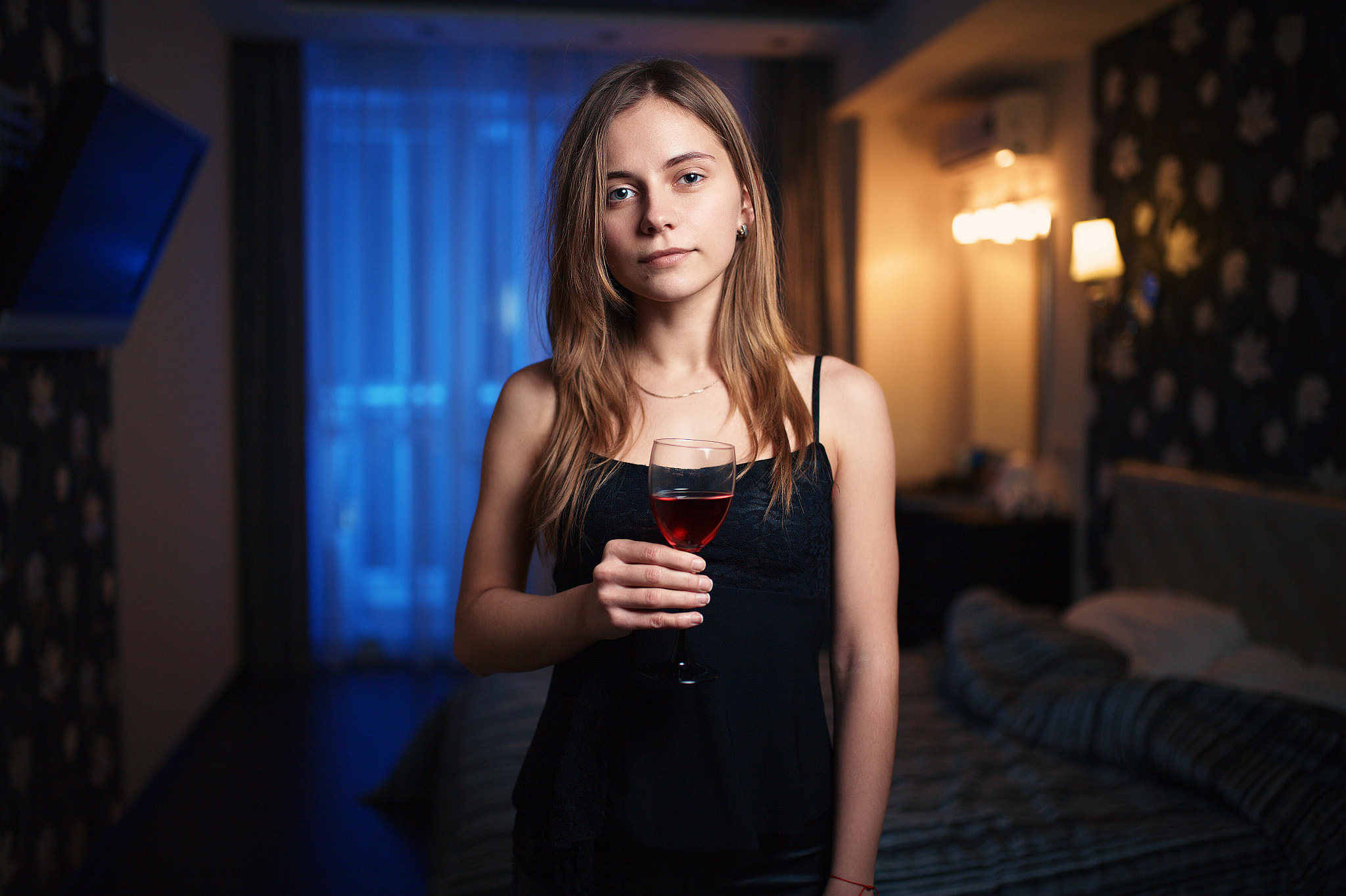 Woman holding a glass of red wine in a bedroom HD Wallpaper
