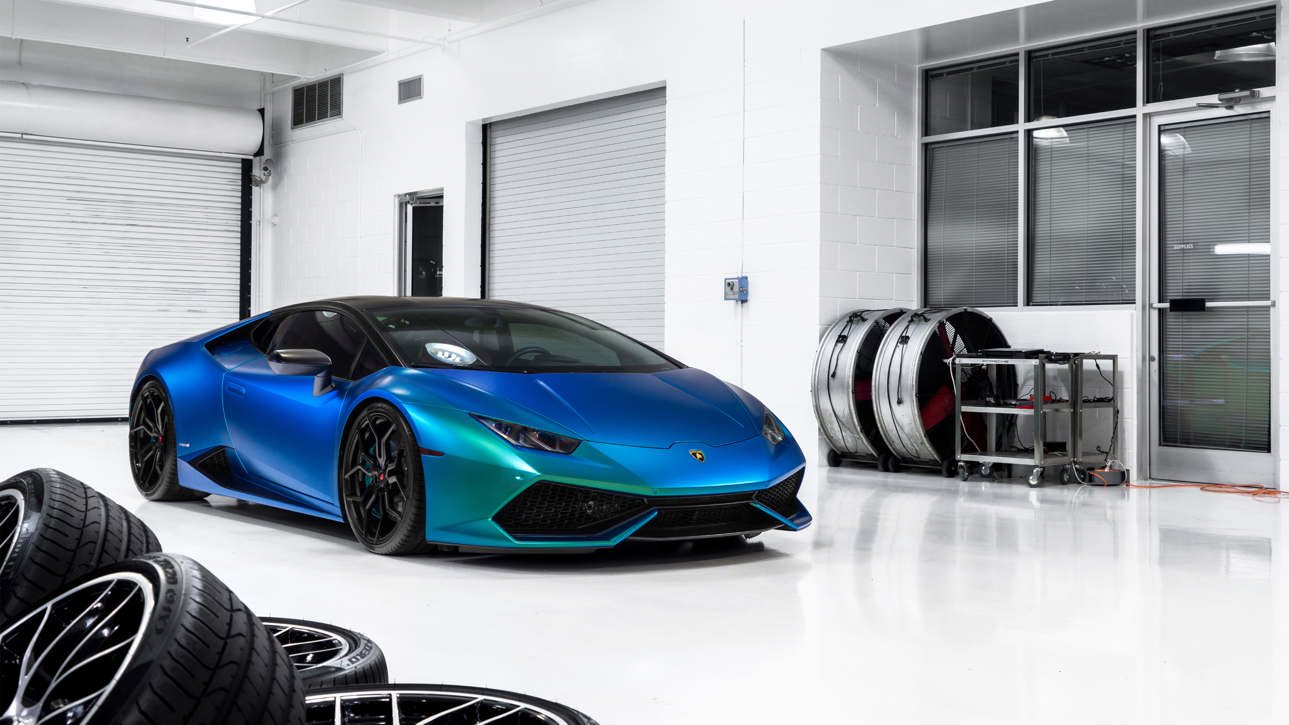 Blue and green Lamborghini Huracan in a garage HD Wallpaper