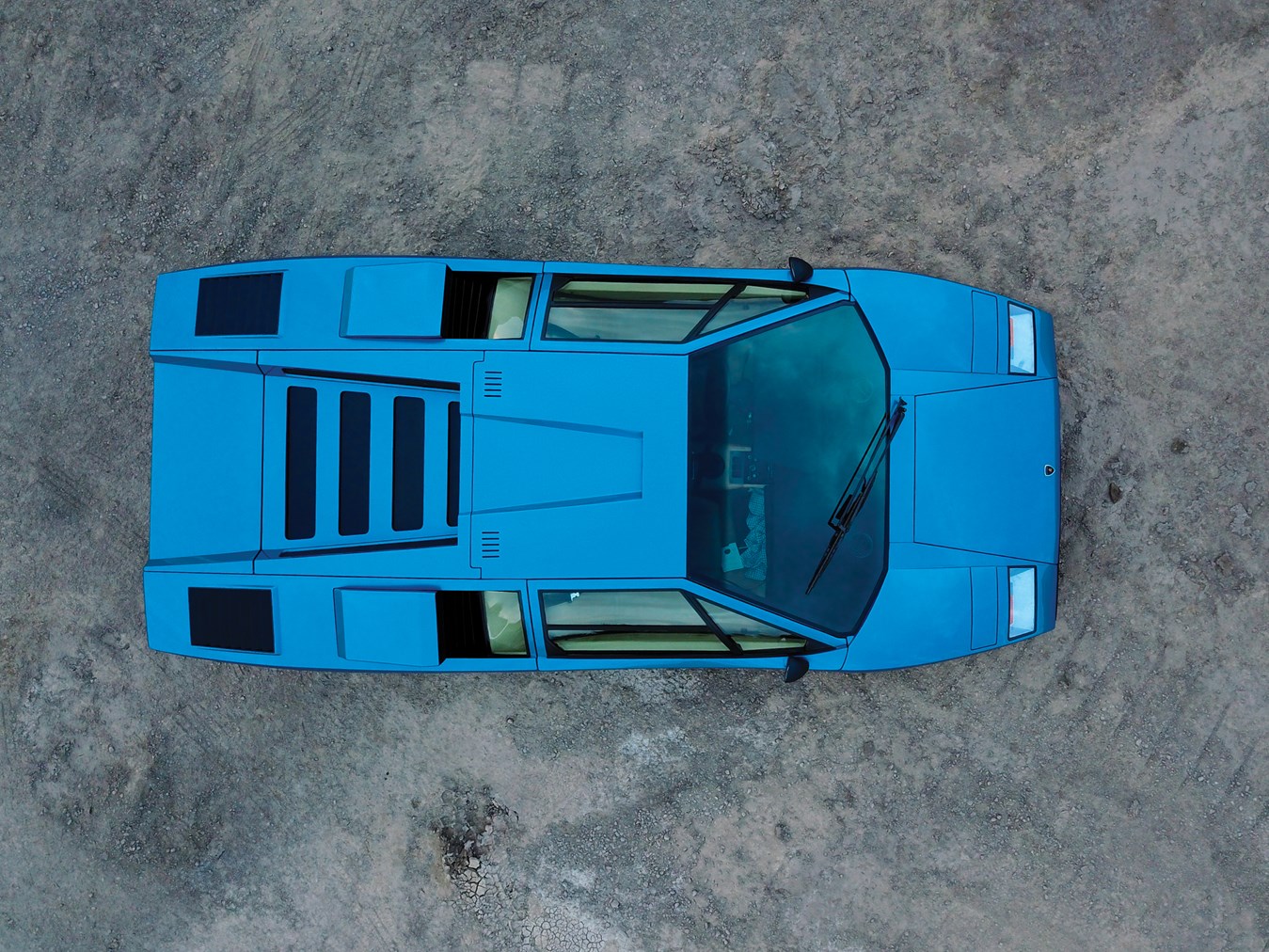 Blue Lamborghini Countach parked on dirt ground HD Wallpaper