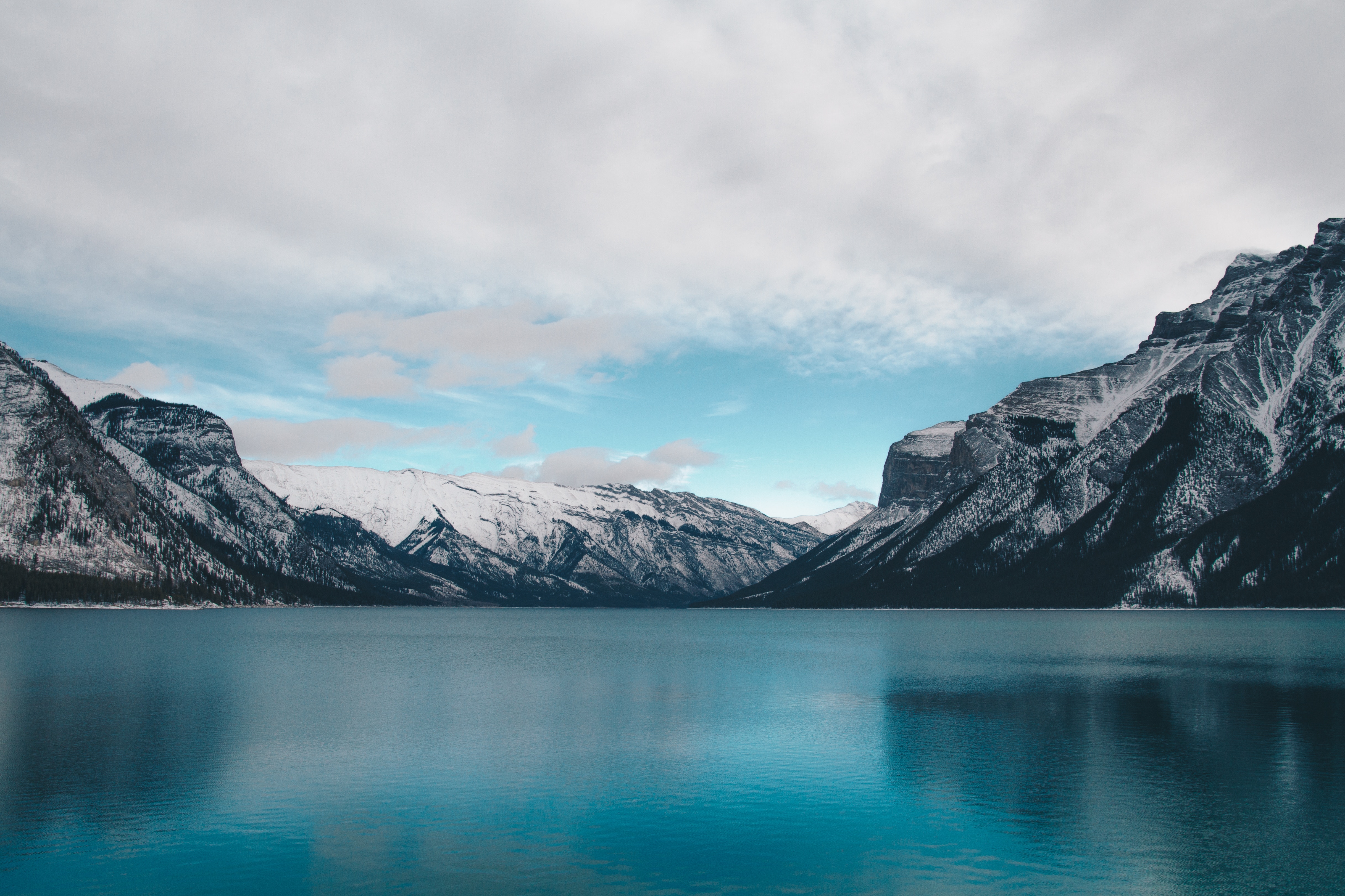 Snow-capped mountains reflecting in a blue lake HD Wallpaper