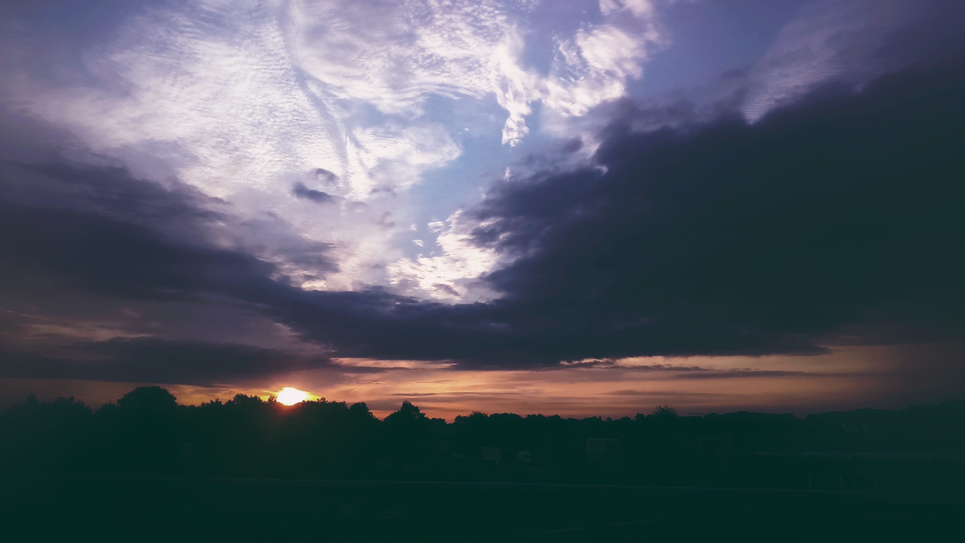 Sunset with colorful clouds over trees HD Wallpaper
