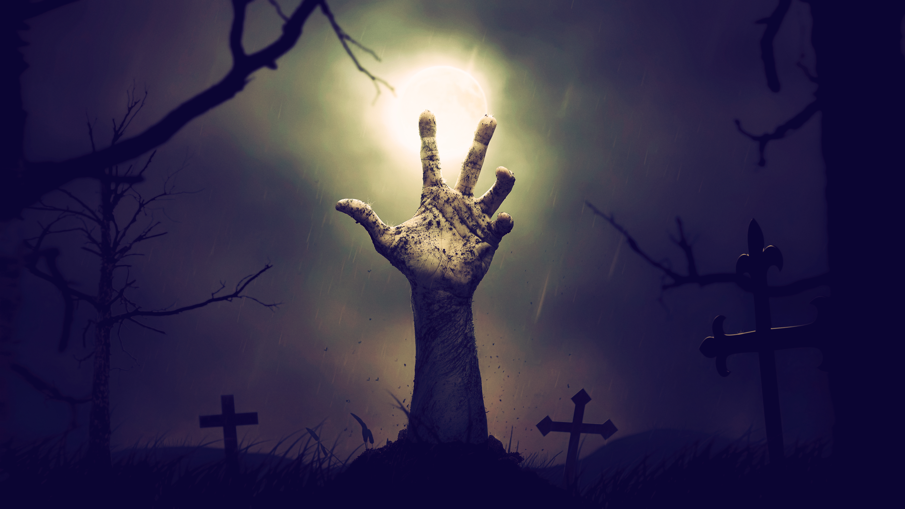 Zombie hand emerging from a graveyard at night HD Wallpaper