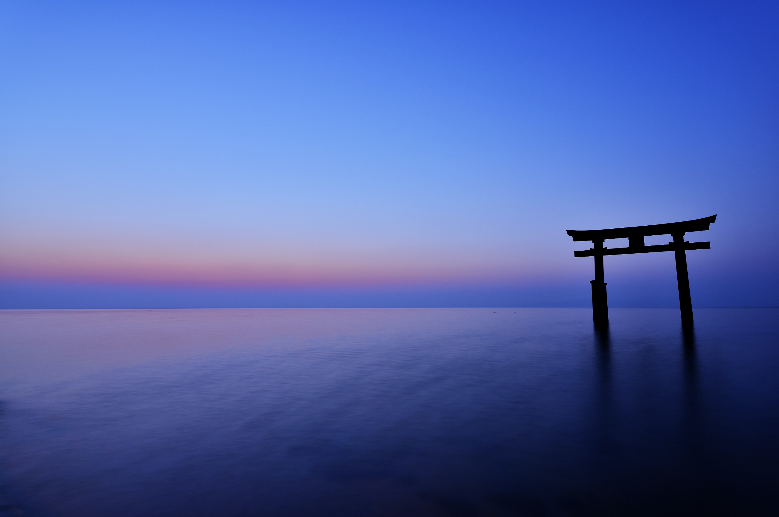 Torii gate in the sea at sunset HD Wallpaper