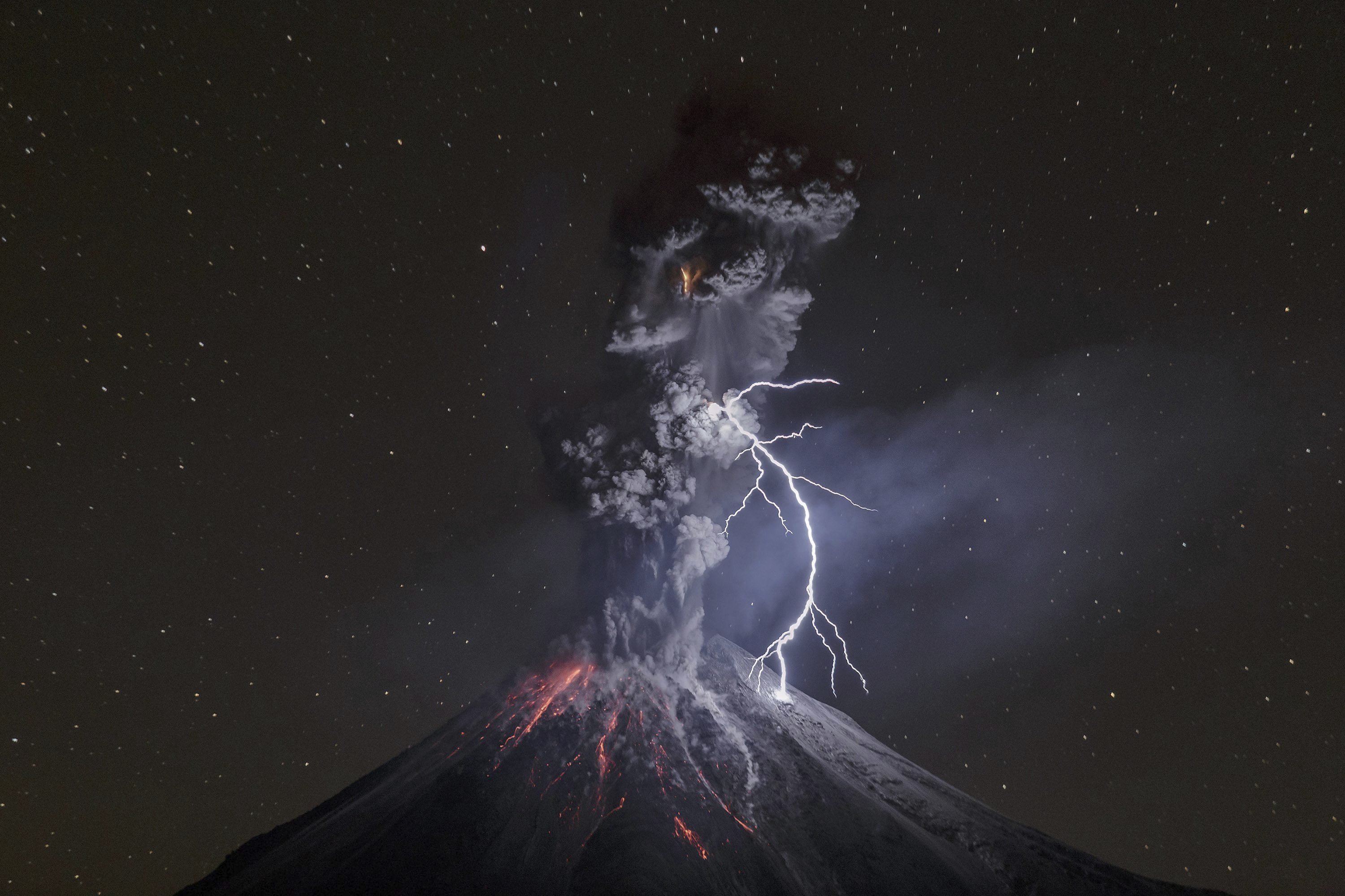 Volcano erupting with lightning at night HD Wallpaper