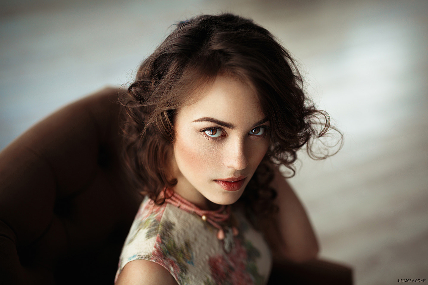 Woman with curly brown hair in a floral dress HD Wallpaper