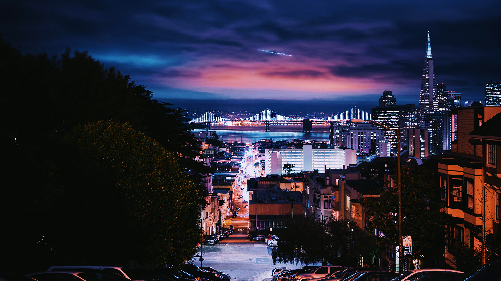 San Francisco cityscape at night with bridges and skyscrapers HD Wallpaper