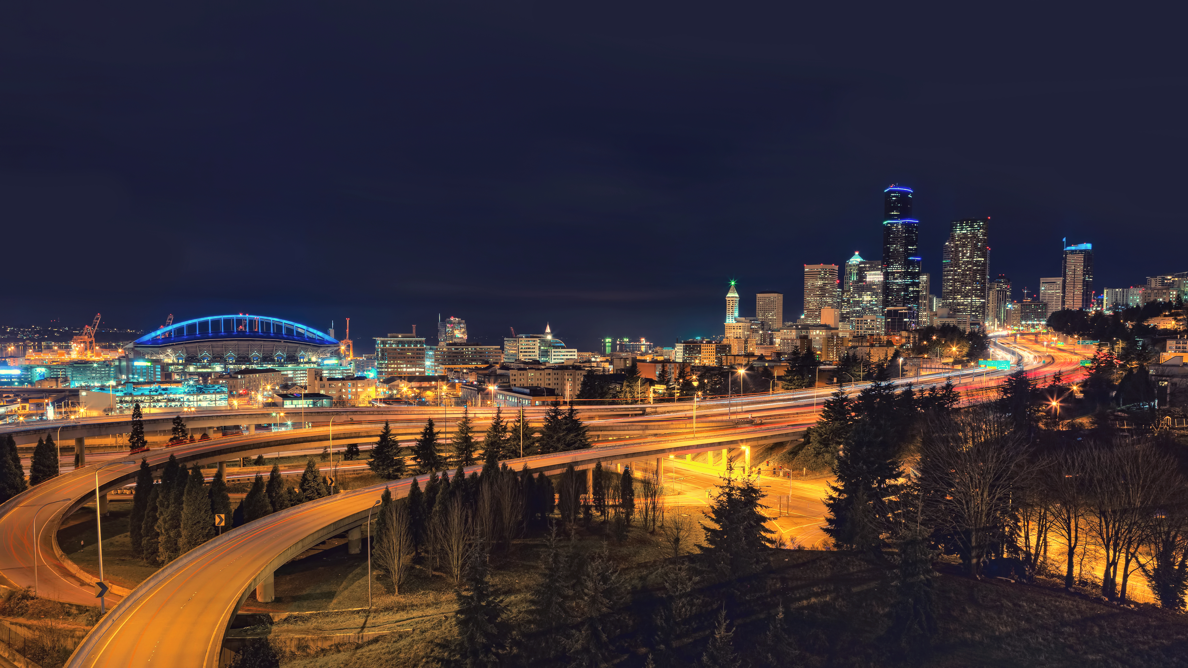 Seattle cityscape at night with stadium and highways HD Wallpaper