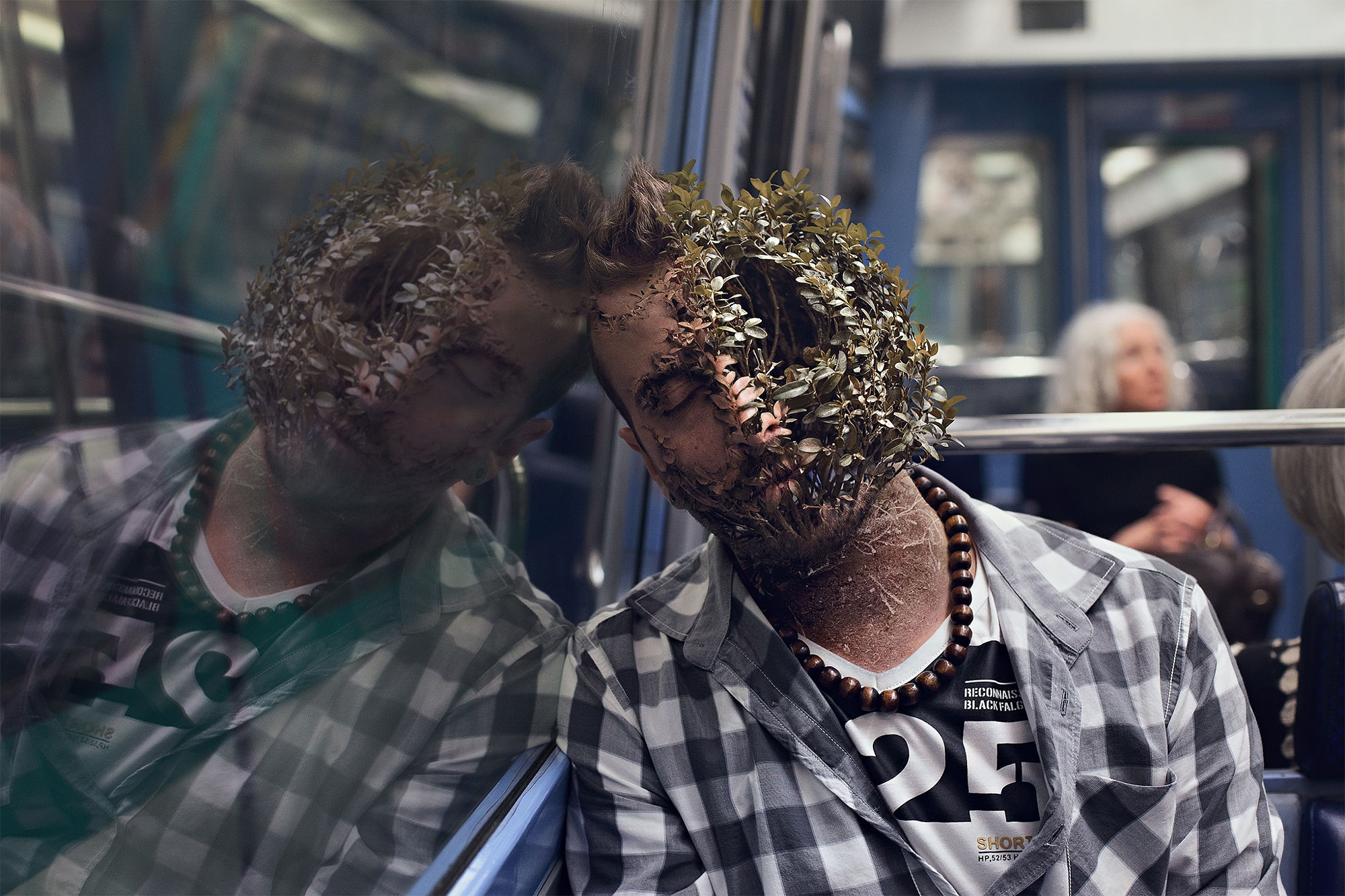 Man with plants on face in subway reflection HD Wallpaper