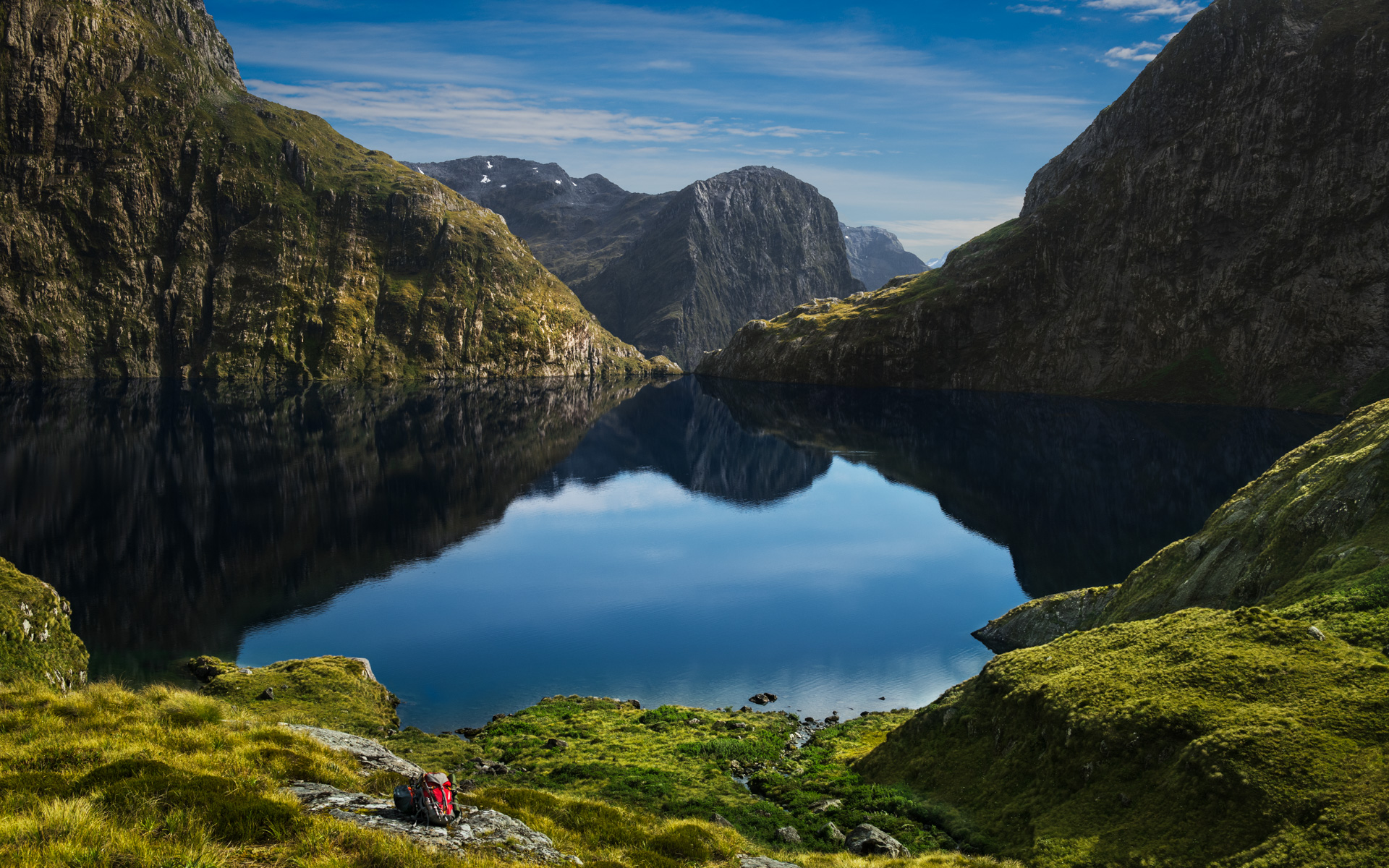 Lake reflecting mountains under a blue sky HD Wallpaper