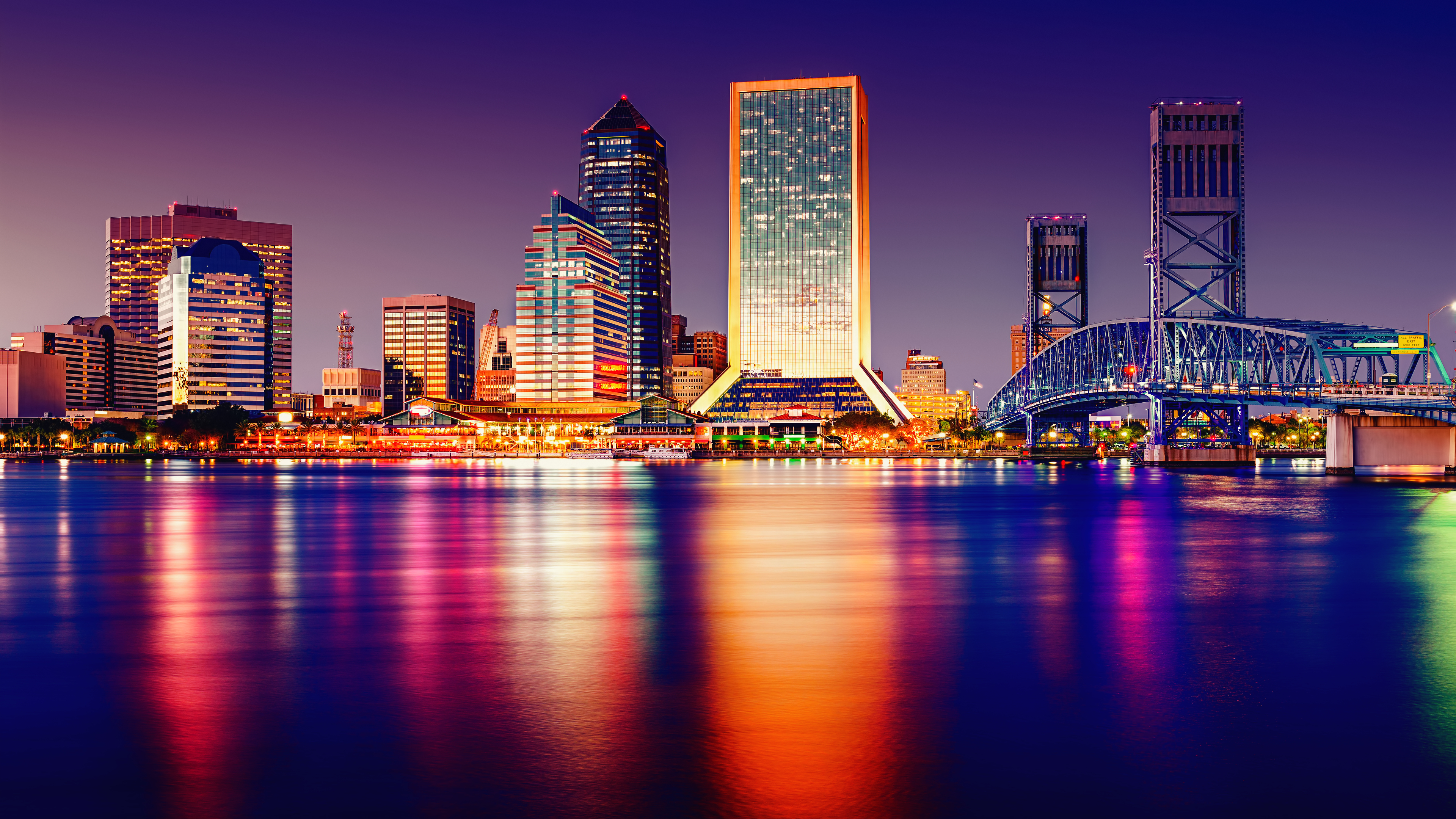 Jacksonville cityscape at sunset with a bridge over water HD Wallpaper